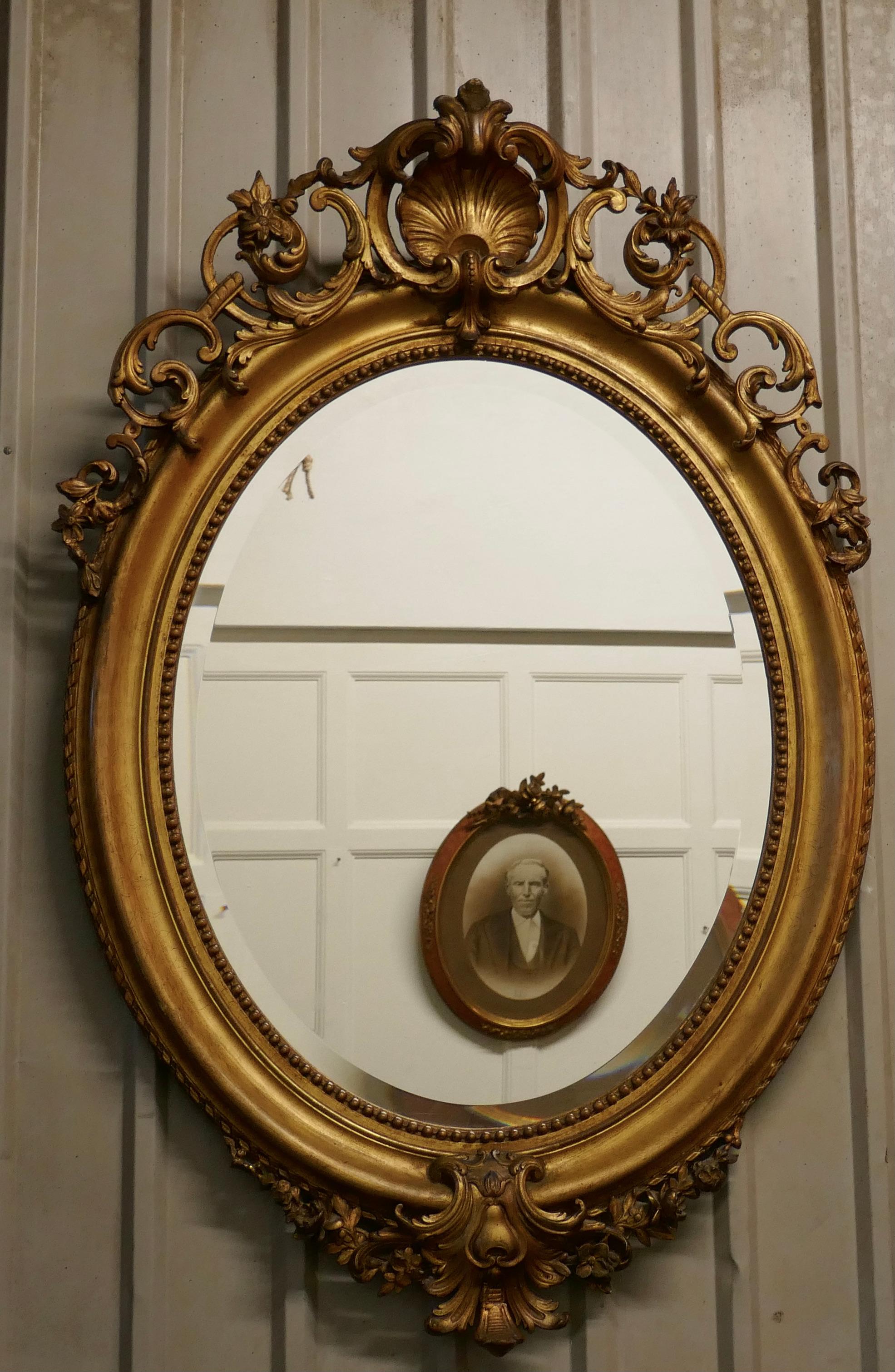 Très grand miroir mural ovale doré de style rococo français    en vente 1