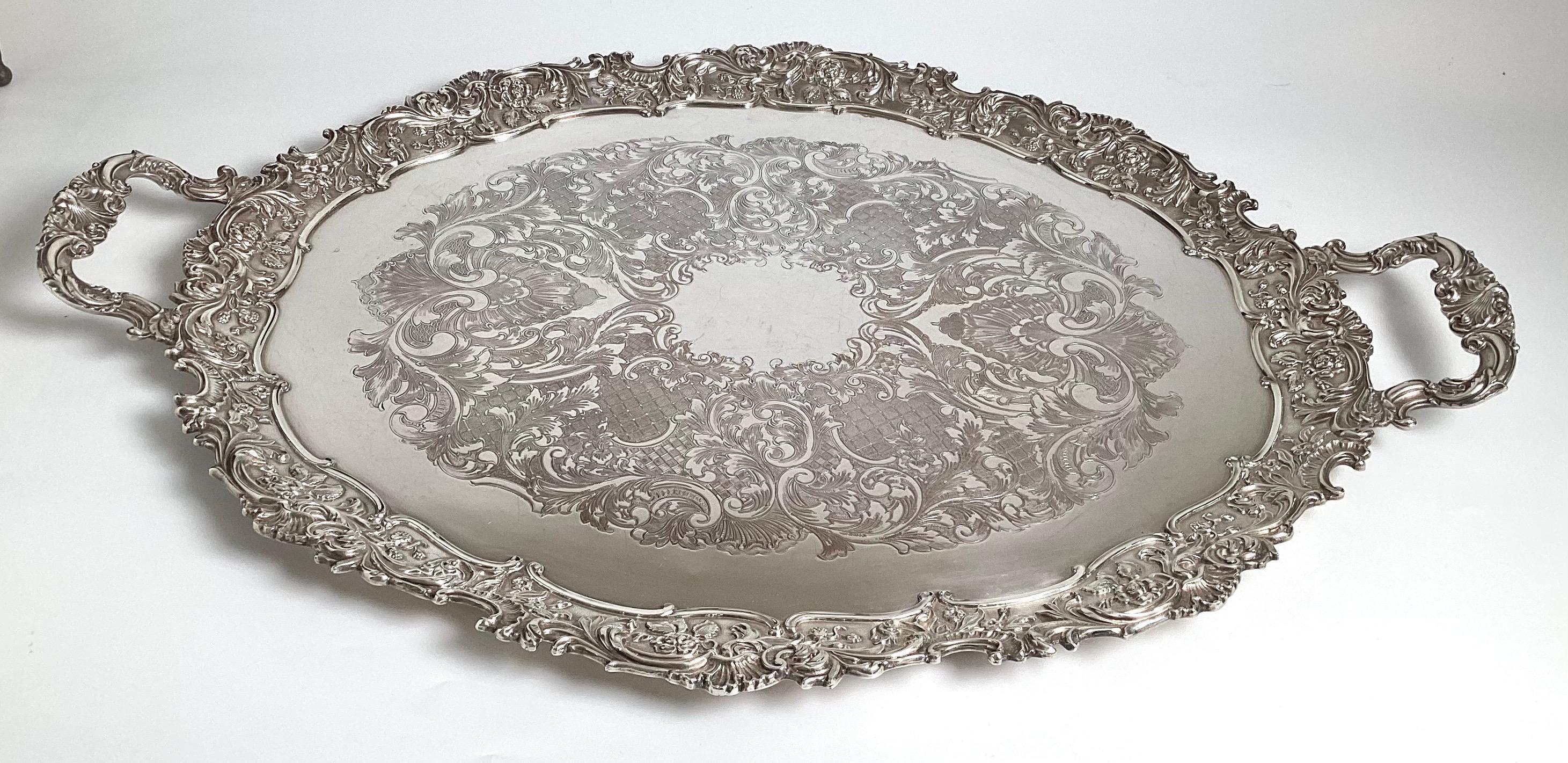An impressive and heavy oval tray by Israel Freeman & Son, England.  The ornate tray with detailed border and handles, Circa 1950, Silver over copper.  Unusual large size 31 inches handle to handle, 22 inches deep. 