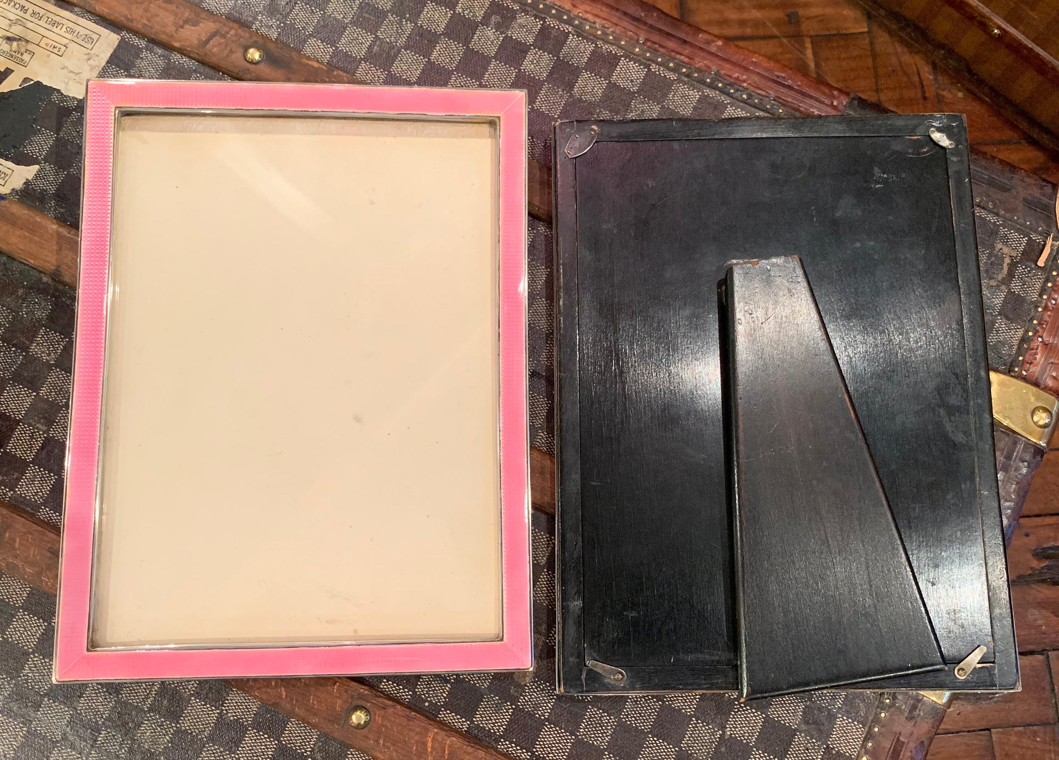 An exceptional and extremely large pair of sterling silver and baby pink Guilloche enamel Art Deco photograph frames.

Both frames having ebony wooden backs. Makers marks are rubbed on both frames, but each is hallmarked for Birmingham