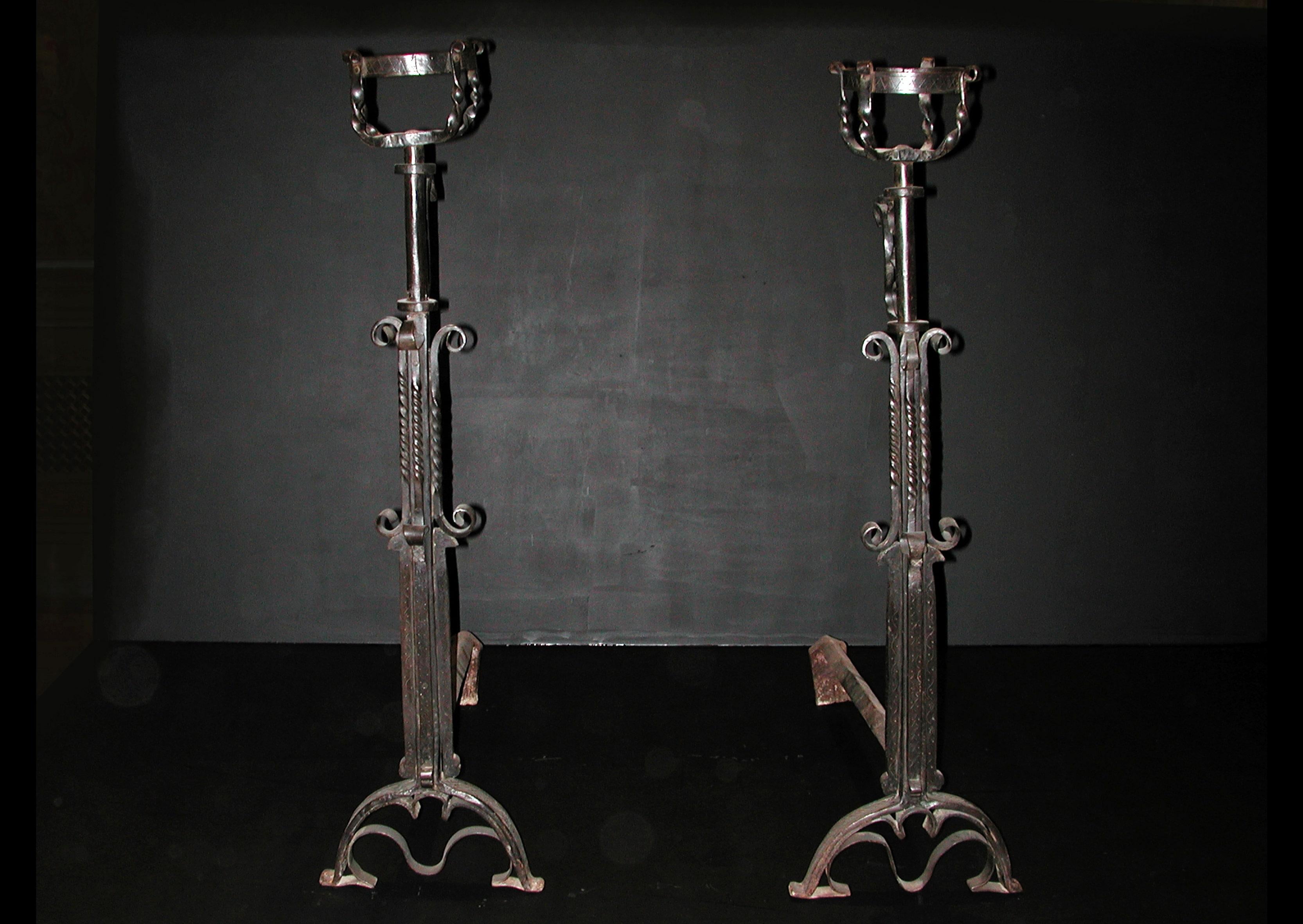 19th century English wrought iron mulling firedogs.

Measures: Height: 1035 mm 40 ¾