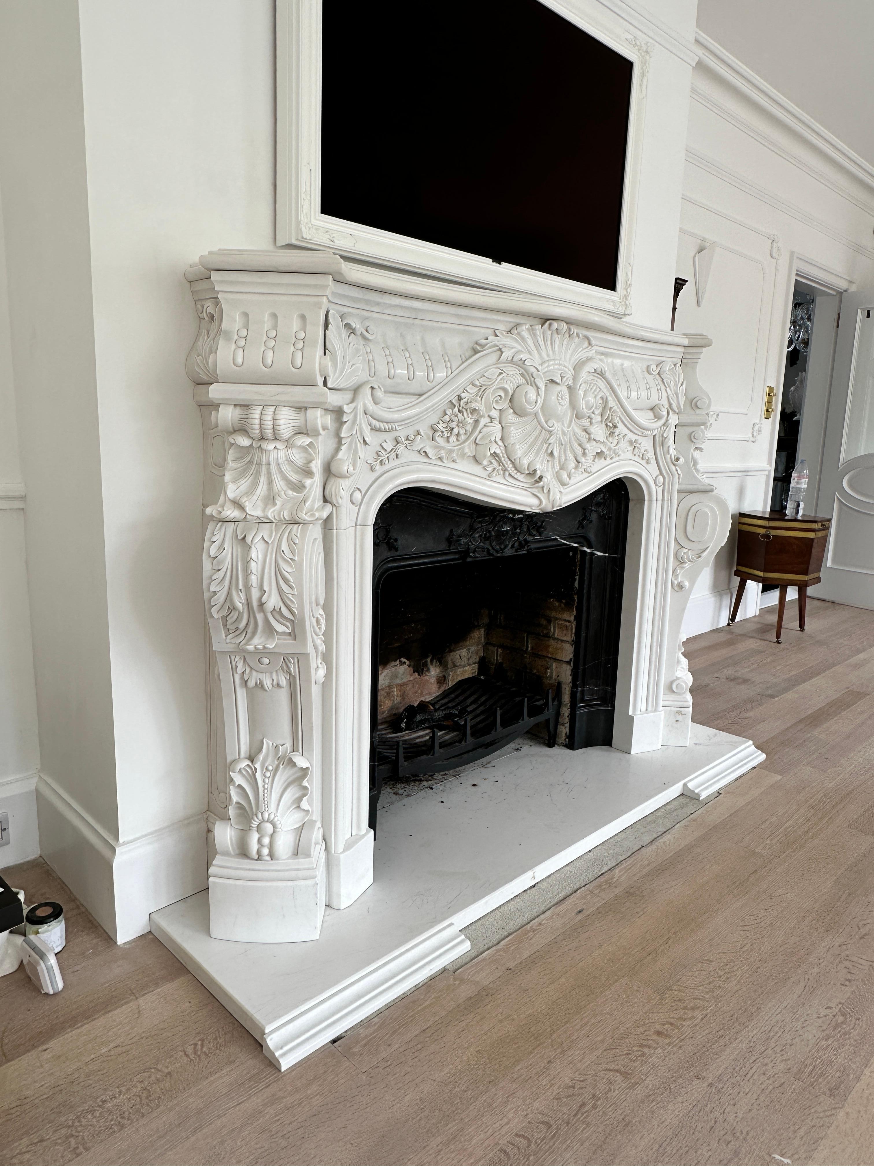 Hand-Carved A Very large Reclaimed French Rococo White Marble Fireplace For Sale