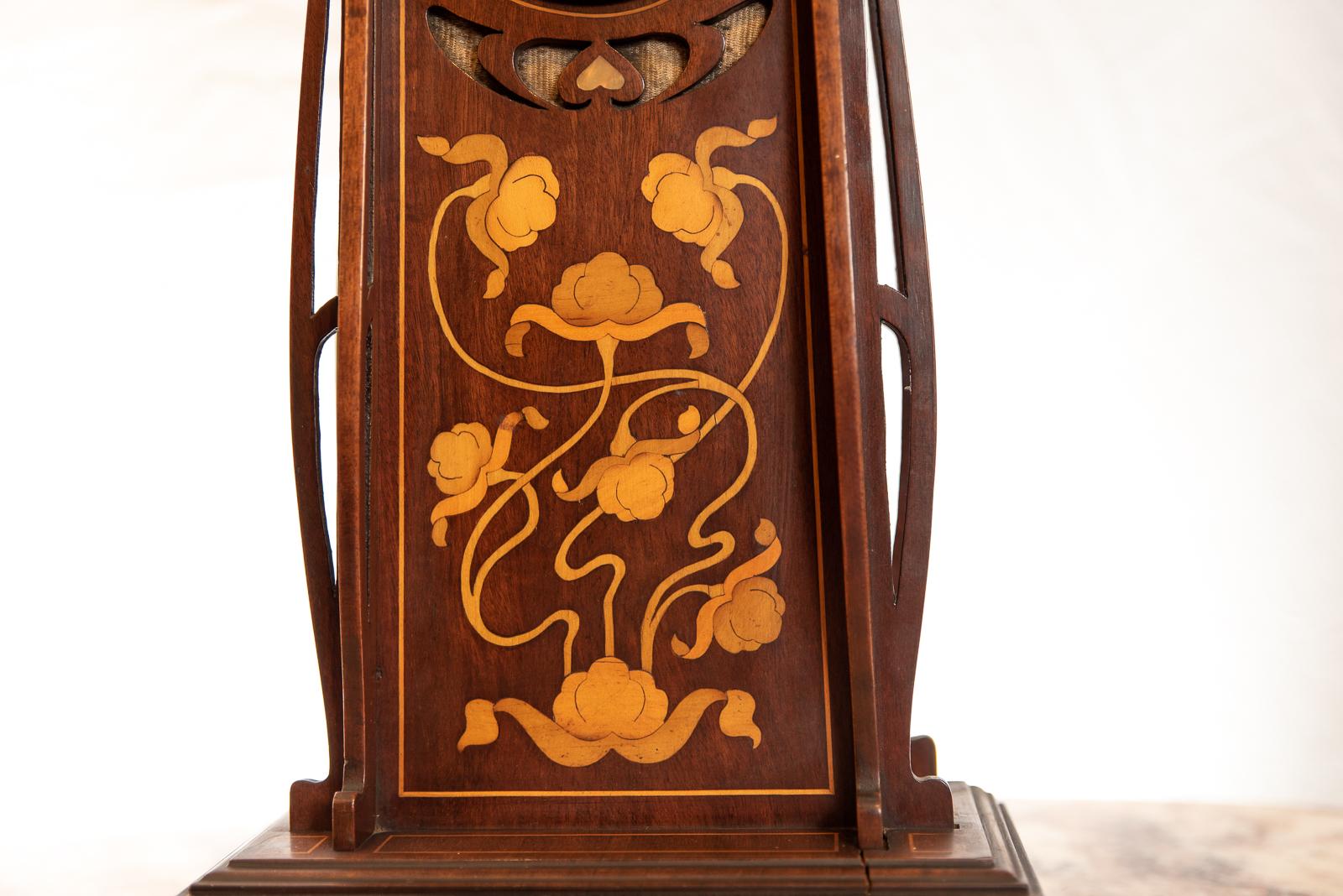 A mahogany and boxwood Art Nouveau mantel clock, with an abundance of inlay (in the Tulip style) and mother of pearl with white Arabic numeral dial. The movement by Duverdry Bloquel of Saint-Nicholas d'Aliermont, France, circa 1900.