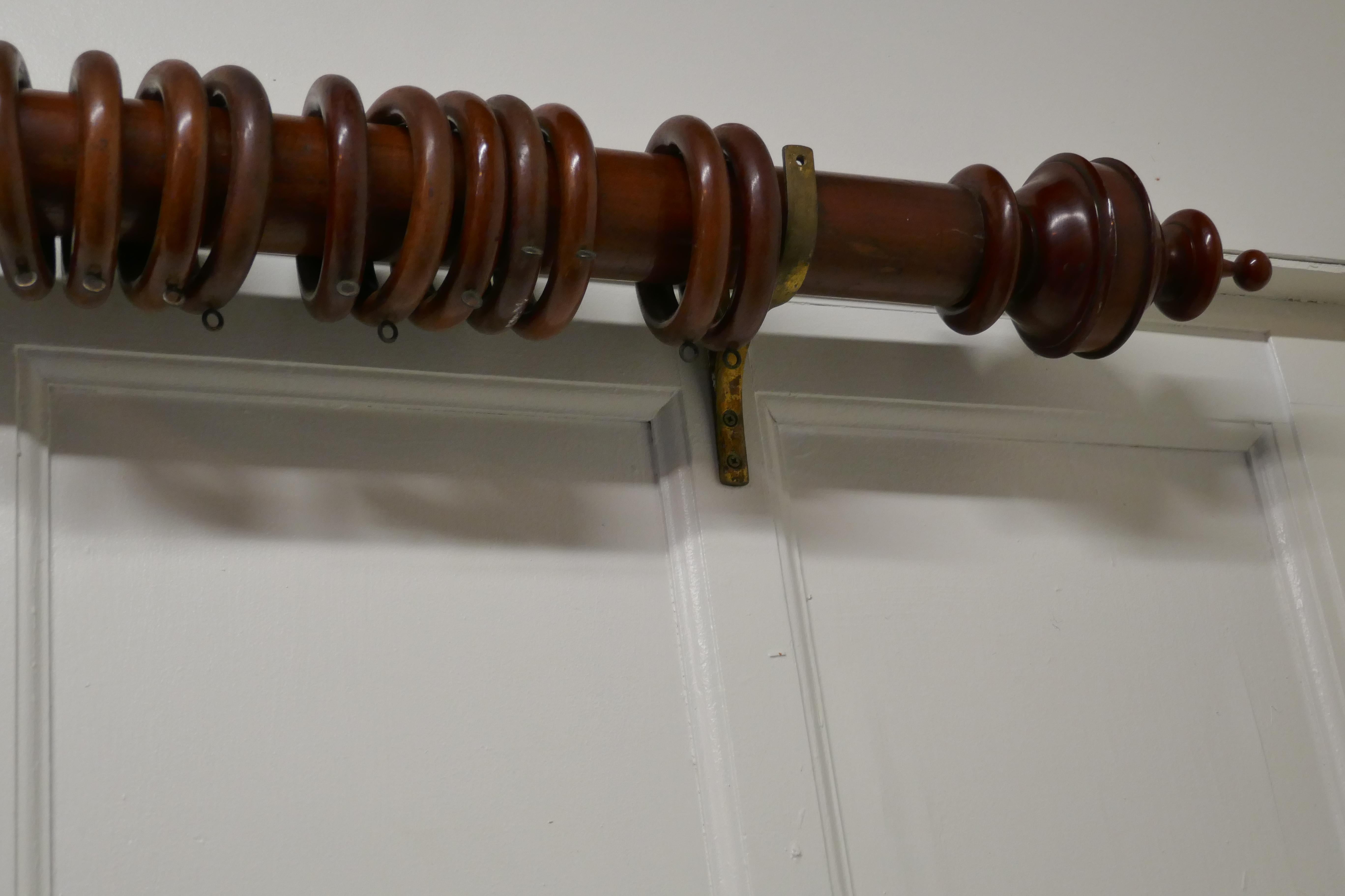 A very long Victorian mahogany curtain pole with rings.

This wonderful and very rare pole is turned from a single piece of mahogany the finished length is 12ft long
The curtain pole is over 3” in diameter, it is all made in mahogany with an