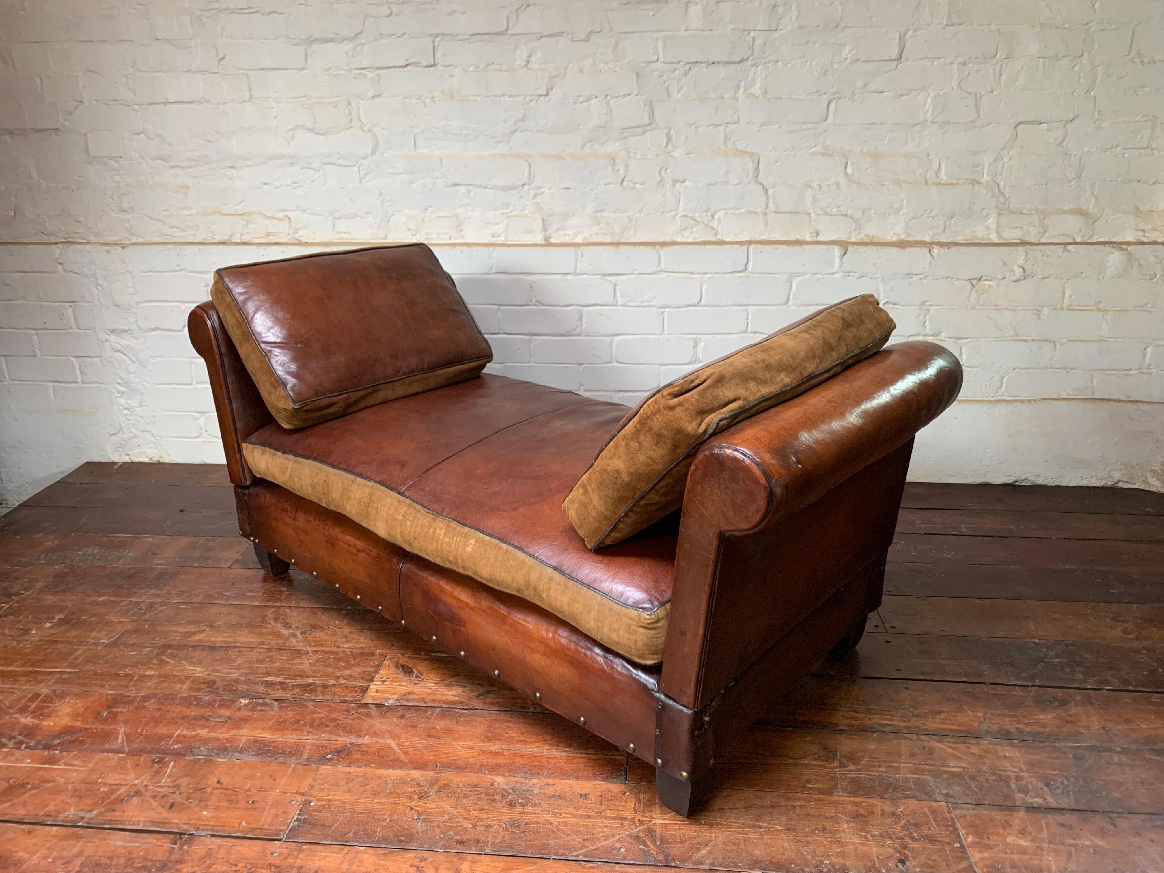 This charming banquette has the rare feature of having its original, leather cushions. The cushions are in leather with a velvet underside for summer / winter usage.
The leather on the banquette is gorgeous and undamaged and has a beautiful Havana