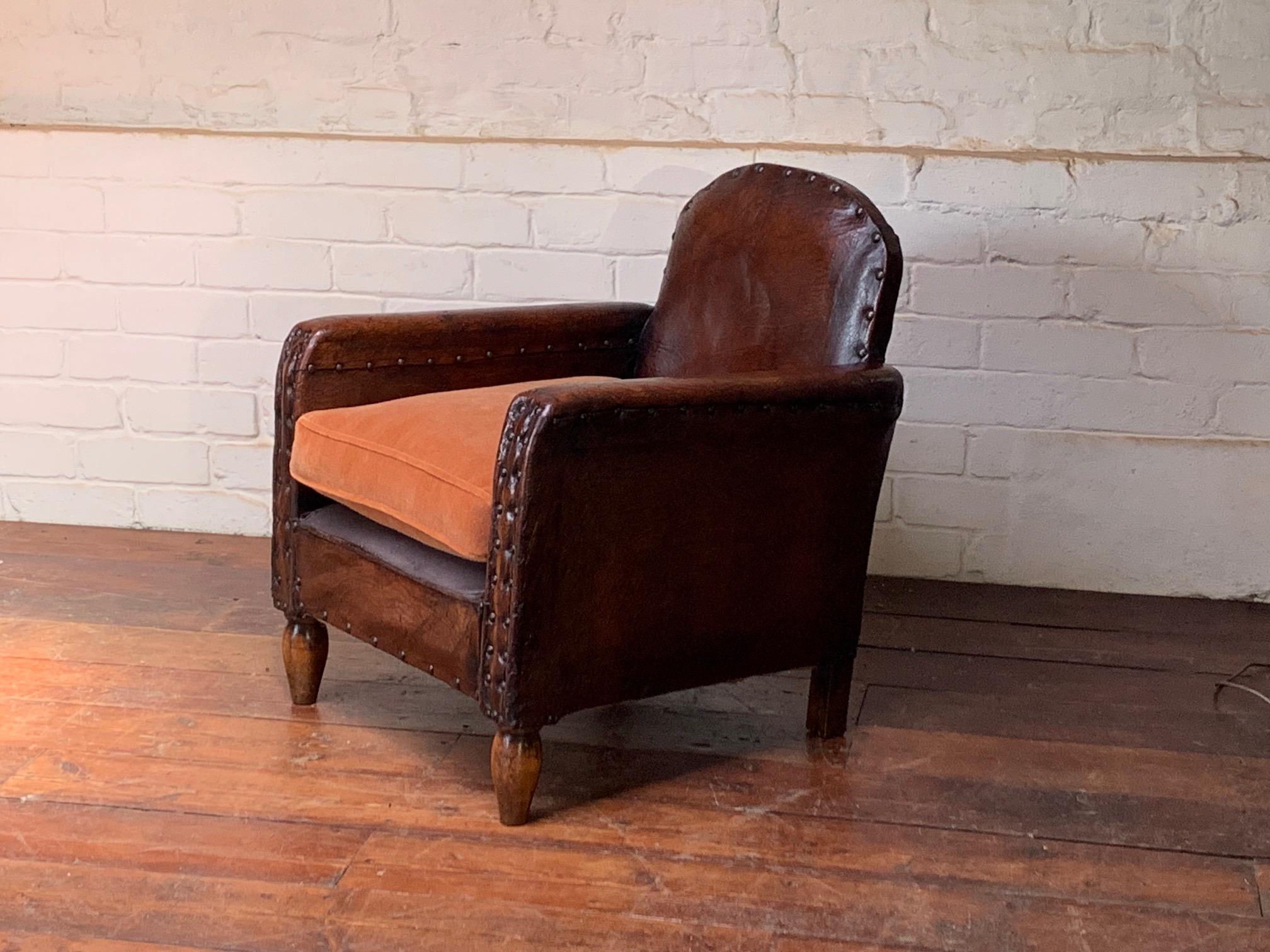 This lovely chair and extremely rare club chair, with its compact design, is in absolutely beautiful original condition. The patination and colour of early French club chairs like this one is just wonderful. The coupling of its simple studwork and