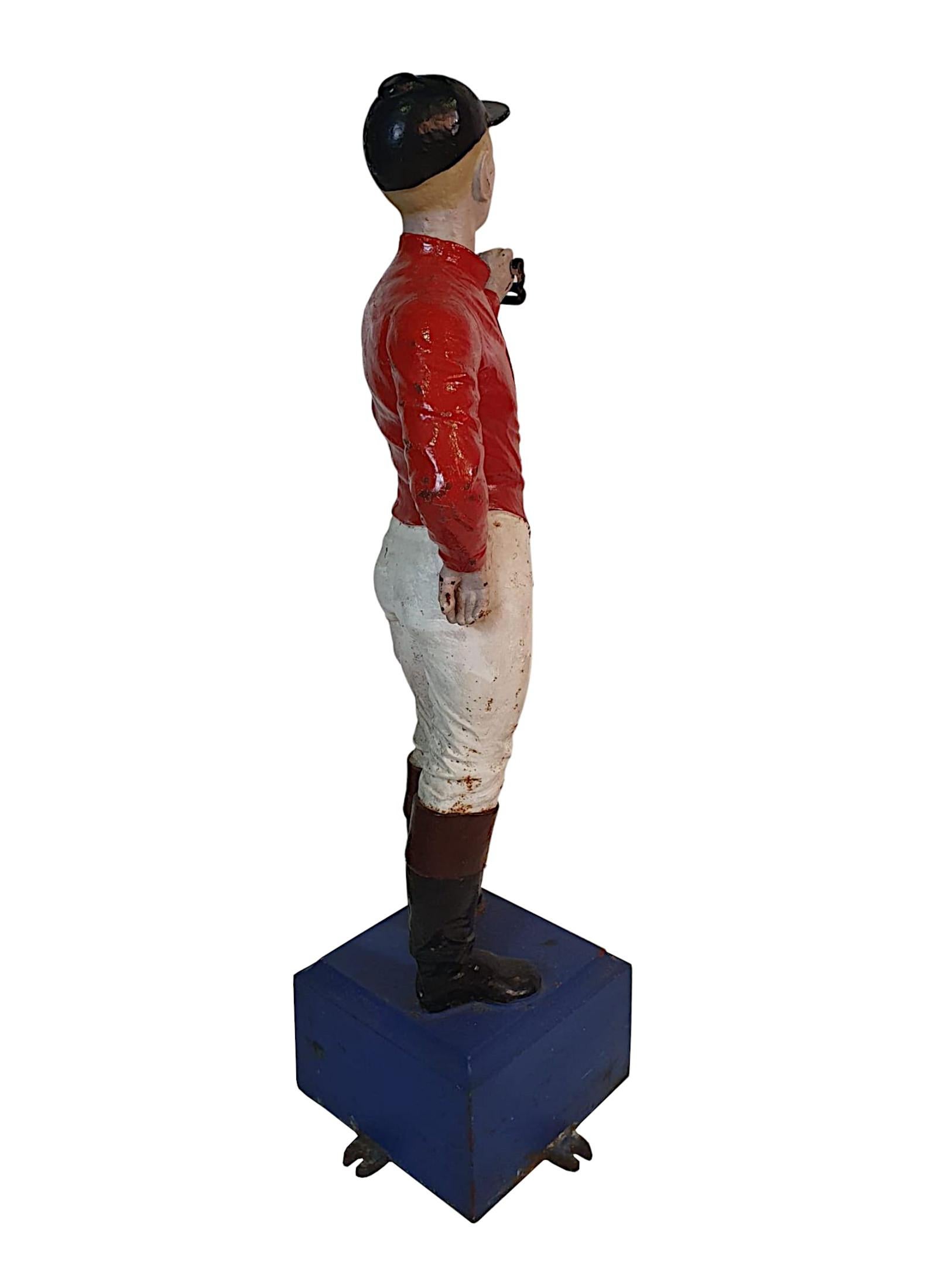 A very rare 19th century cast iron equine hitching post in the form of a jock-ey. The jockey is classically dressed in the 19th century riding attire, com-prising of a black riding hat, red jacket and cream jodhpurs. The jockey is poised on a