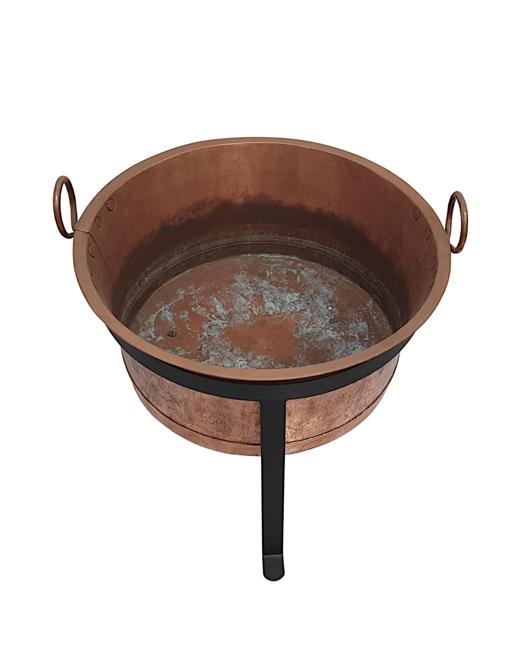 A very rare 19th Century copper log bucket of large proportions.  The finely crafted body of oval form with a gorgeous patina, everted rim and loop handles is supported on a lovely new handmade black metal stand.

Bucket on Stand Width: 30 in / 76 cm