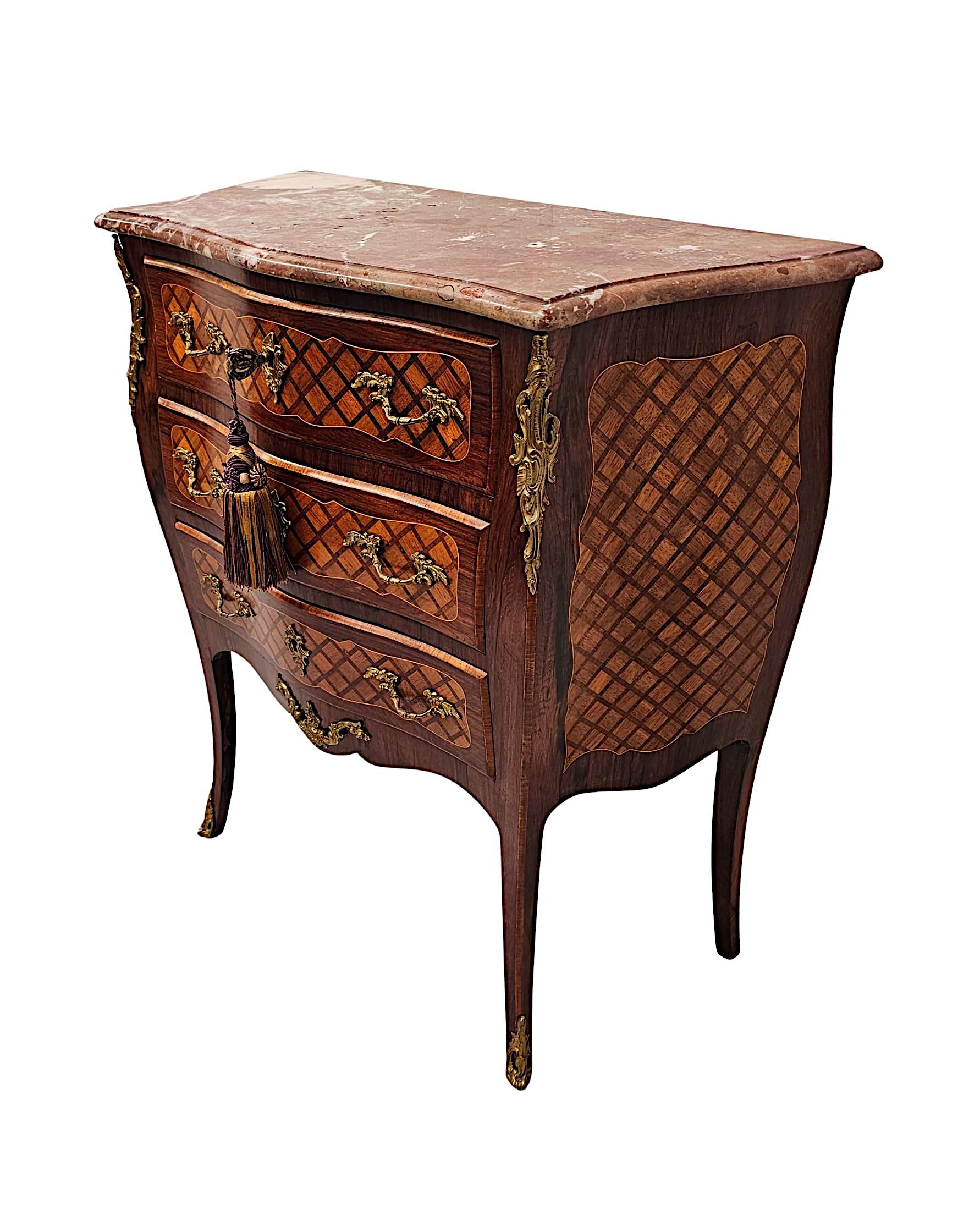 A very rare 19th Century marble top kingwood and fruitwood chest of neat proportions.  This gorgeous piece is of exceptional quality, finely hand carved, line inlaid and ormolu mounted throughout with beautifully rich patination and grain.  The