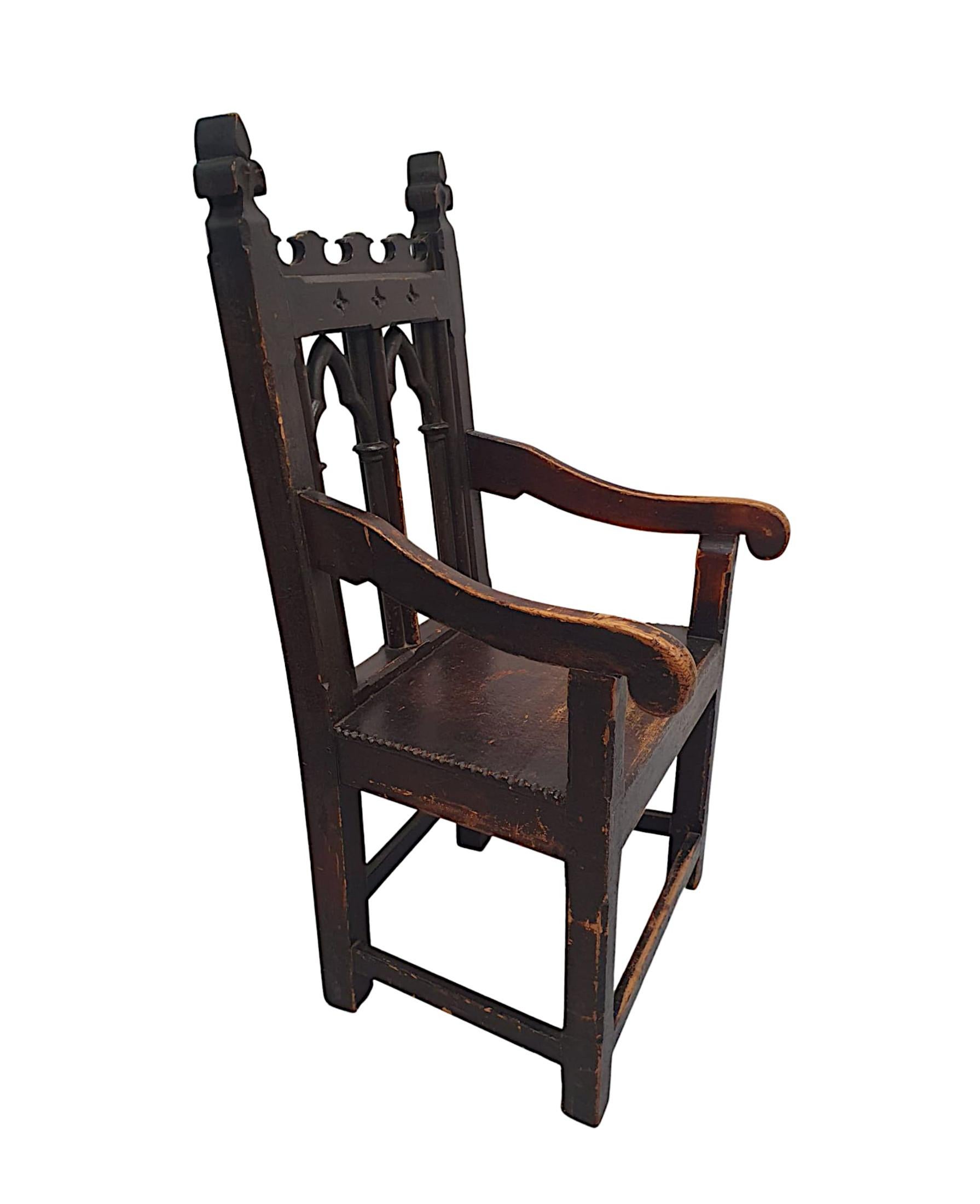 A very rare and fine 19th Century well figured, richly patinated elm and pine Gothic armchair of exceptional quality.  The fabulously hand carved, ornate and decorative top rail is raised over a shaped and pierced catherdral arched shaped open