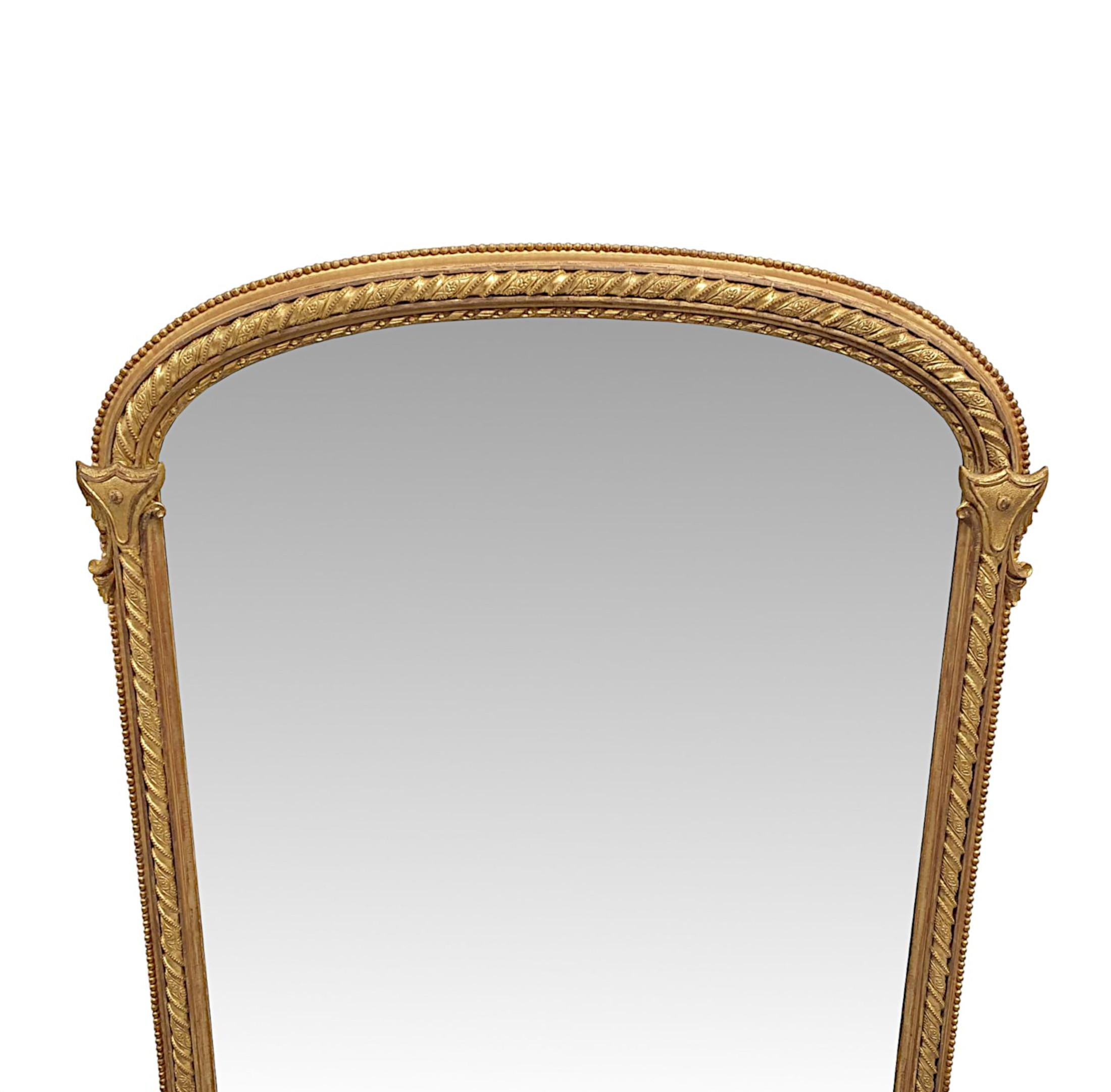 A very rare and fine 19th Century gilt wood overmantel mirror of grand proportions and exceptional quality. The mirror glass plate of rectangular form with an arched top is set within a fabulously hand carved, moulded and fluted giltwood frame with