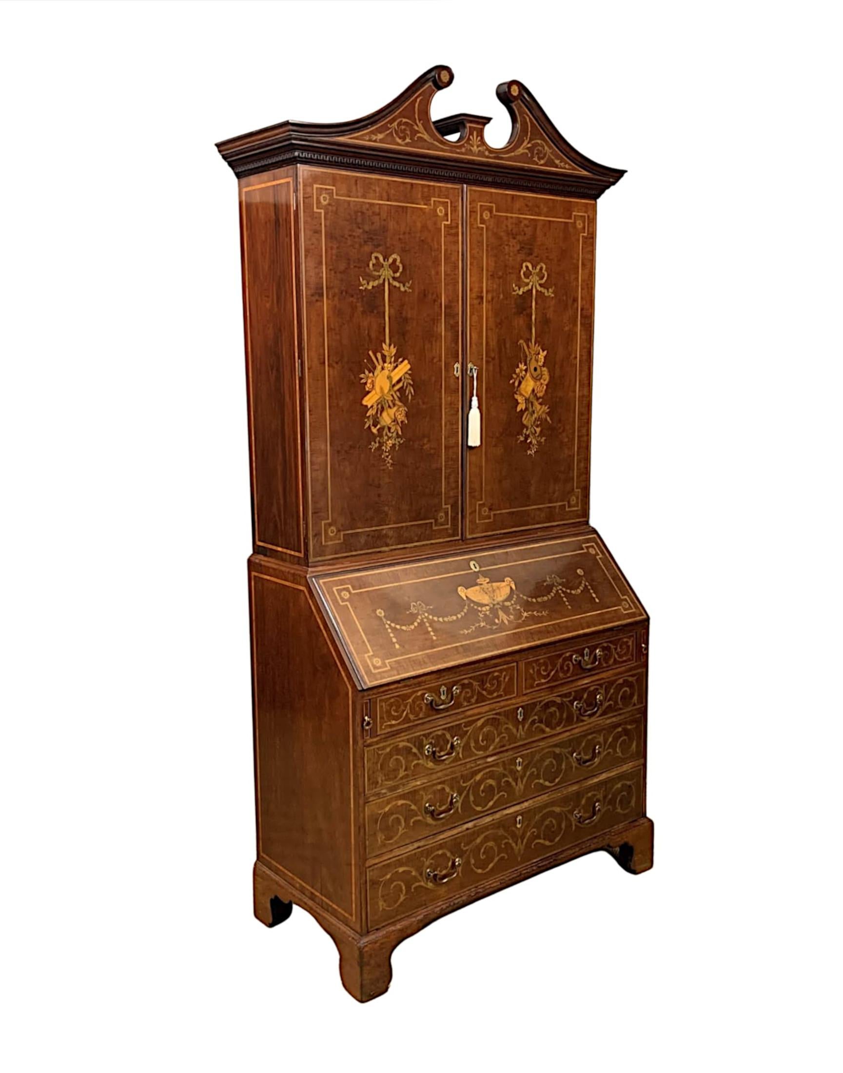 A very rare and fine early 19th century Georgian mahogany bureau bookcase, line inlaid throughout and with intricate marquetry depicting Neoclassical motifs of swags, garlands, flower heads and scrolling detail. The moulded stepped broken swan neck