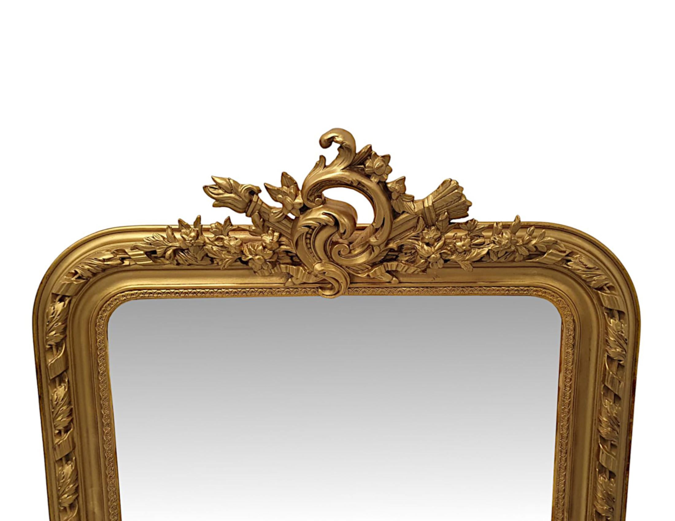 A very rare and fine pair of 19th century giltwood mirrors. The mirror glass plate is set within a beautifully hand carved, moulded and shaped giltwood frame of rectangular form with ribbon, foliate, egg and dart border motif detail. Surmounted with