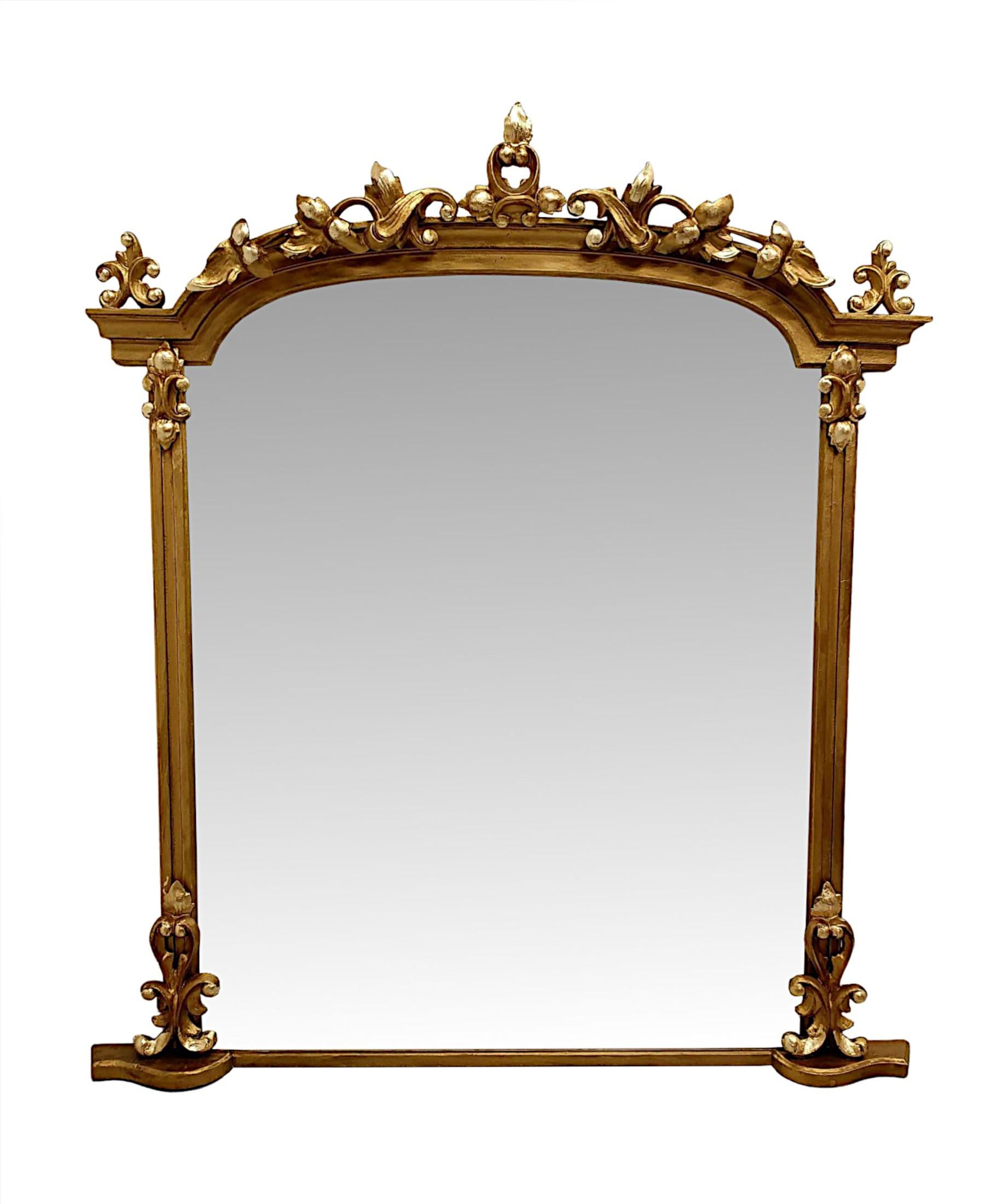 A very rare and fine pair of 19th Century giltwood overmantle mirrors.  The bevelled mirror glass plate of shaped, rectangular form is set within a finely hand carved, moulded and fluted giltwood frame surmounted with curved architectural