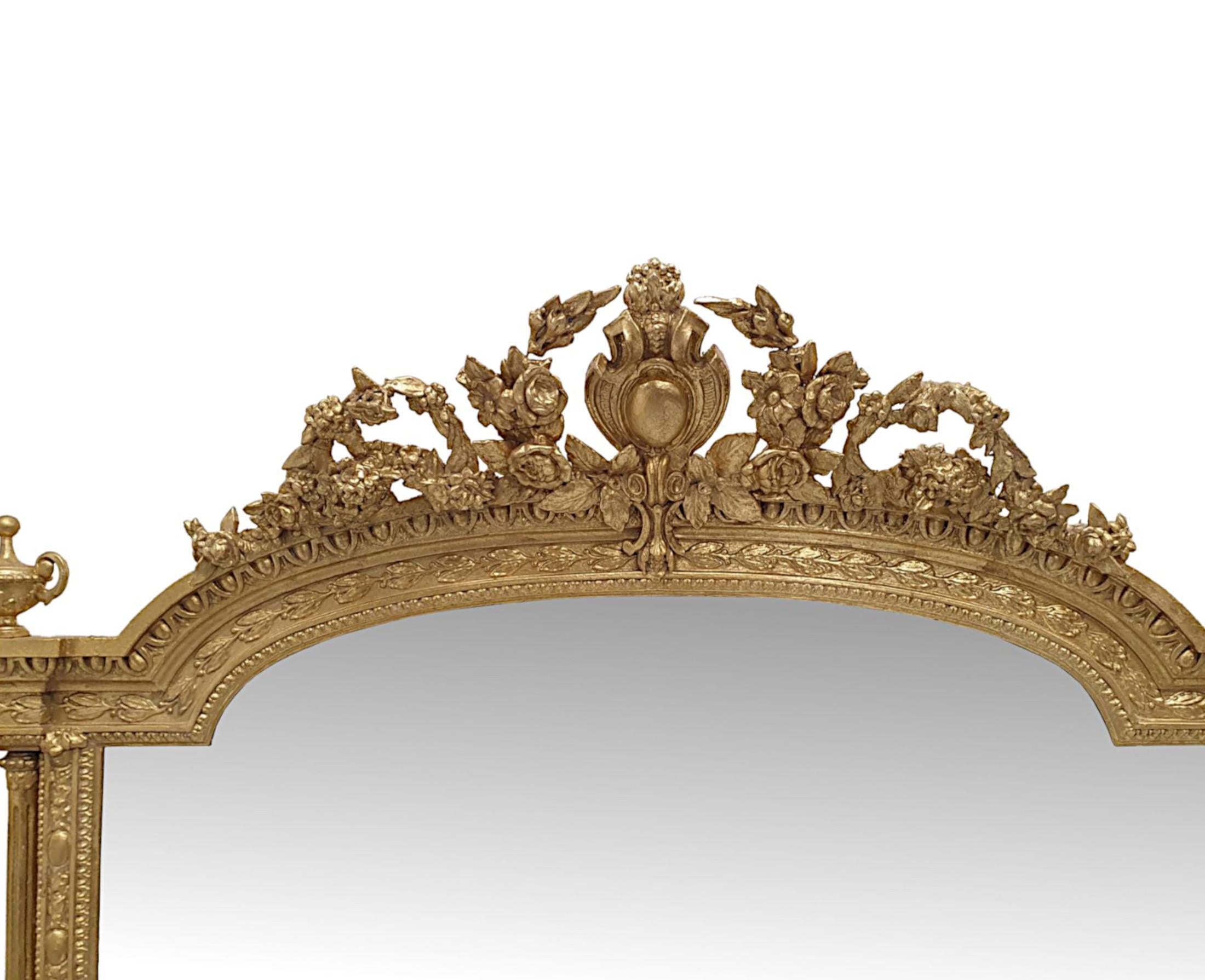 A very rare and impressive 19th Century giltwood overmantle mirror of grand proportions.  The mirror glass plate of rectangular form with curved top is set within a finely hand carved moulded and fluted giltwood frame with elegantly simple
