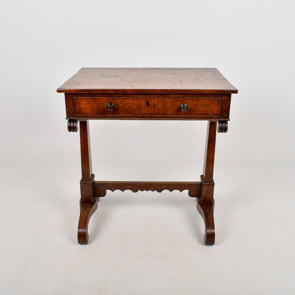 An exceptional and rare example of burr Elm furniture. This occasional table is a beautiful example of a Georgian occasional table on unusual bracket feet with a single drawer to the front.