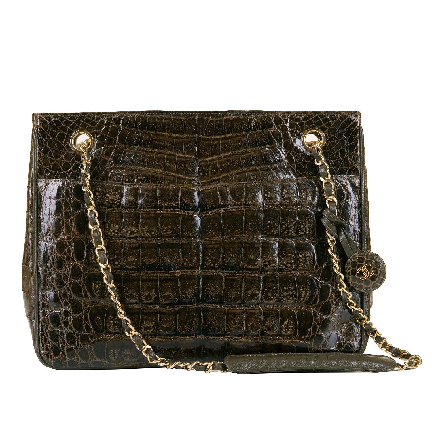 This exquisite vintage Chanel 28cm alligator shoulder bag, designed by Karl Lagerfeld, is from Chanel's 'Pret a Porter' Collection of 1985. With gold hardware, and a featured double 'C' logo tag, the bag is accented with matching brown lambskin