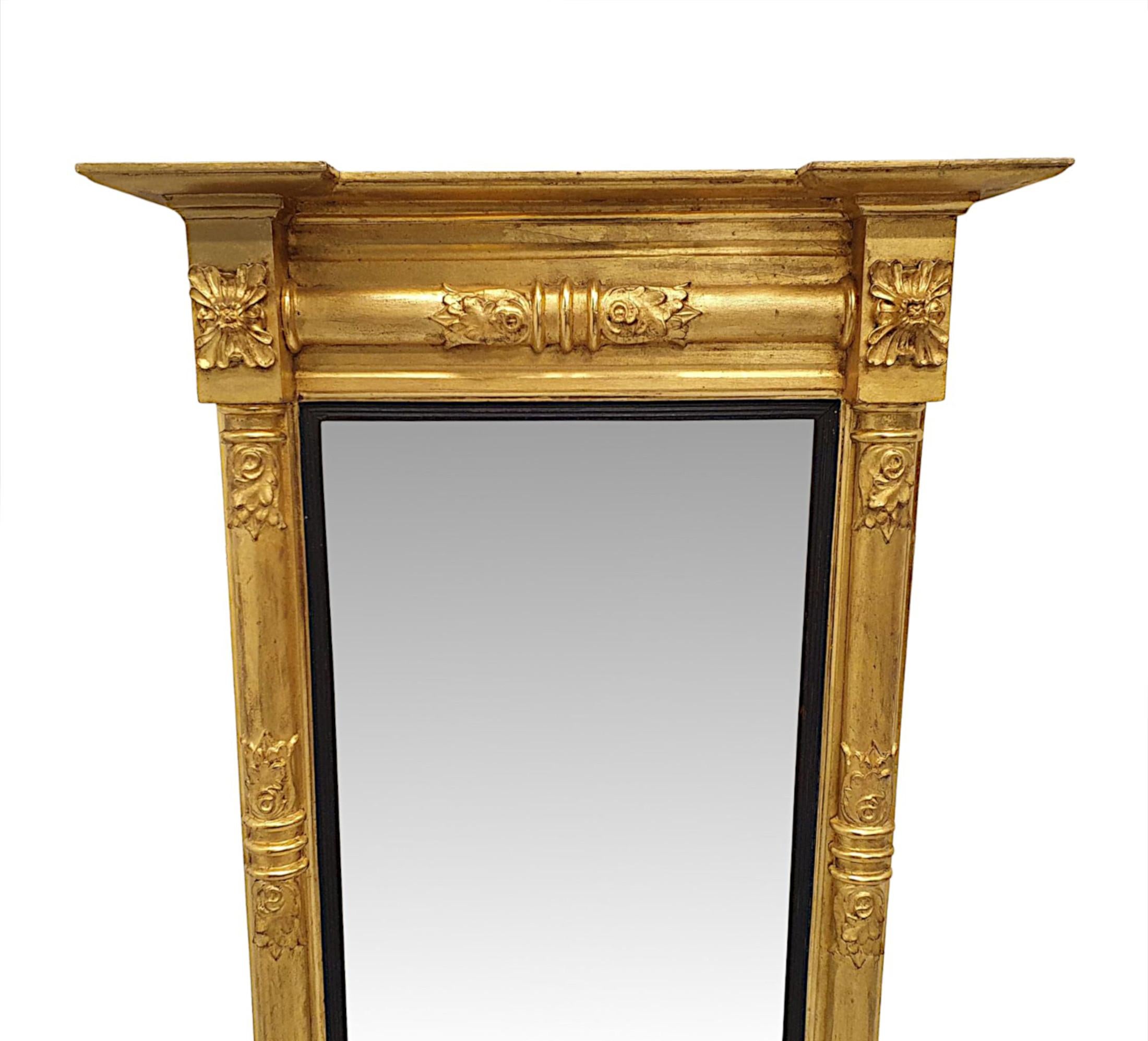 A very rare early 19th Century William IV giltwood pier mirror finely hand carved and of exceptional quality.  The moulded and fluted giltwood frame is surmounted with an overhanging inverse breakfront pediment above panelled frieze with beautifully