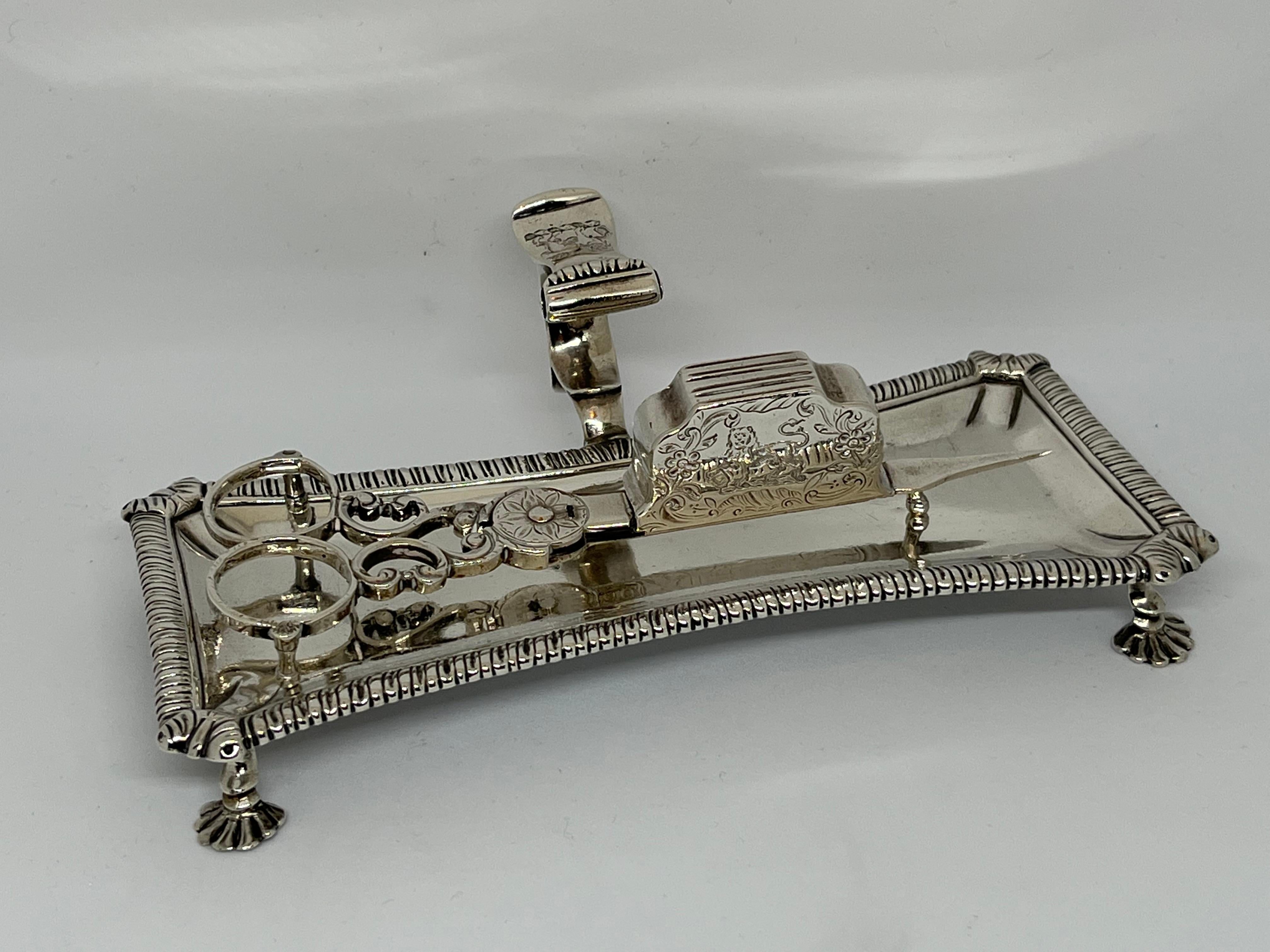 A very rare eighteenth-century silver matching snuffer on stand.

George III silver matching snuffer on original stand, the snuffer tray with gadroon border and acanthus leaf corners, atop four pad feet, the snuffers with scroll cut and chased