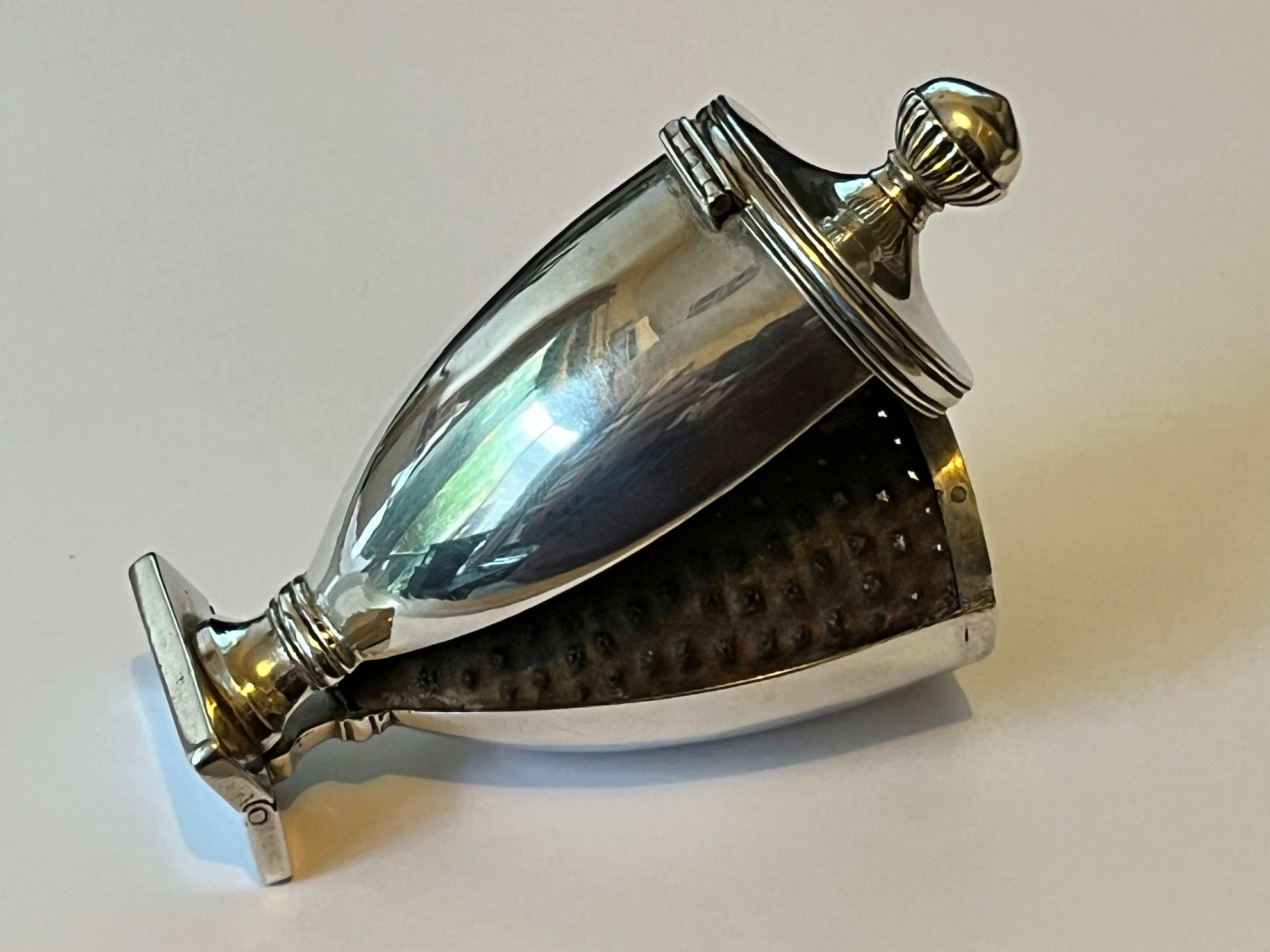 An extremely rare late eighteenth-century George III silver Neoclassical urn nutmeg grater, with hinged cover to the top and semi-fluted spherical form finial, the body sitting atop a rectangular pedestal form foot. The foot is also hinged and once