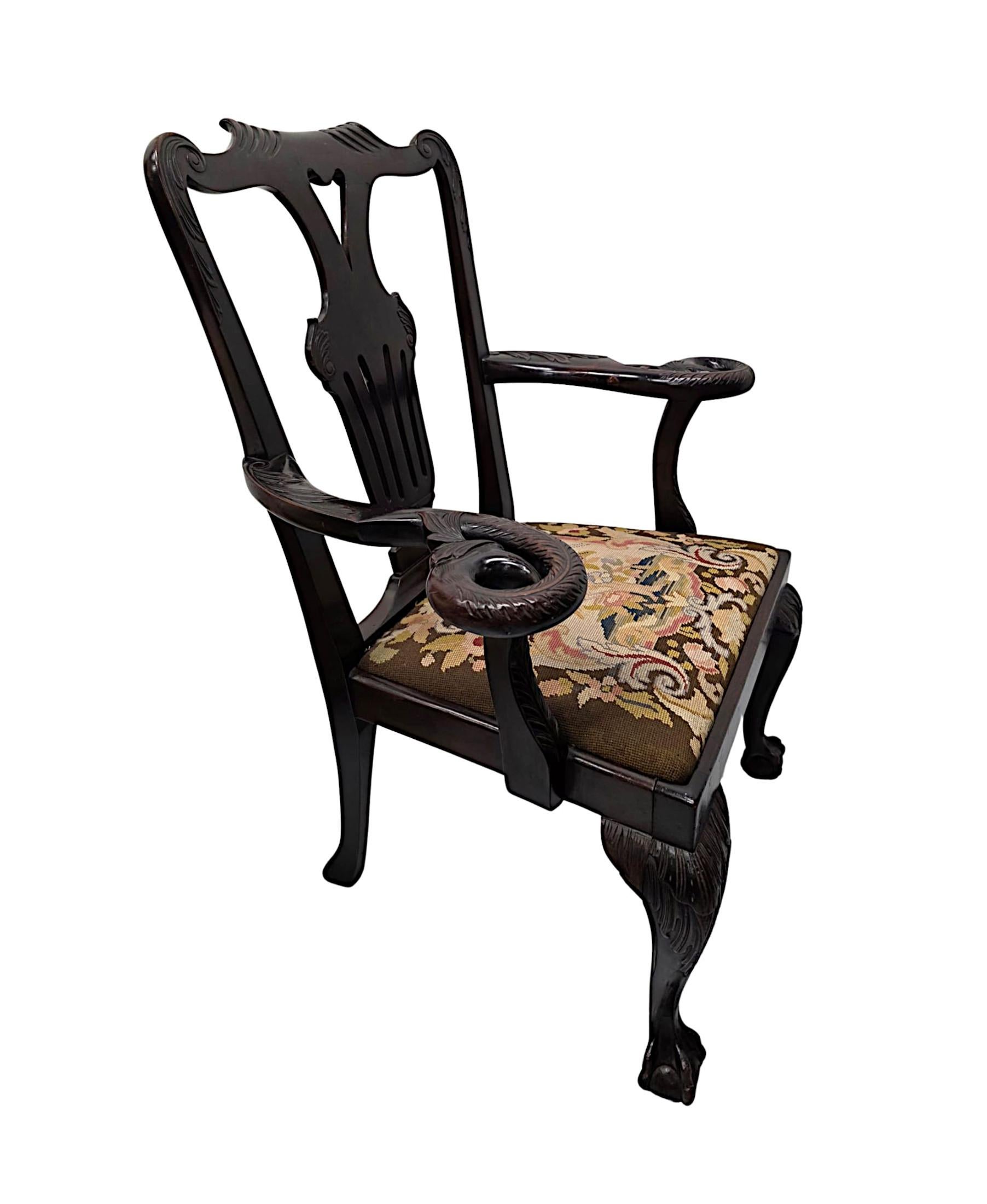 A very rare Irish 19th Century well figured mahogany armchair attributed to 'Butlers' of Dublin.  This stunning piece is of exceptional quality, finely hand carved with beautifully rich patination and grain.  The bow shaped top rail with scroll and
