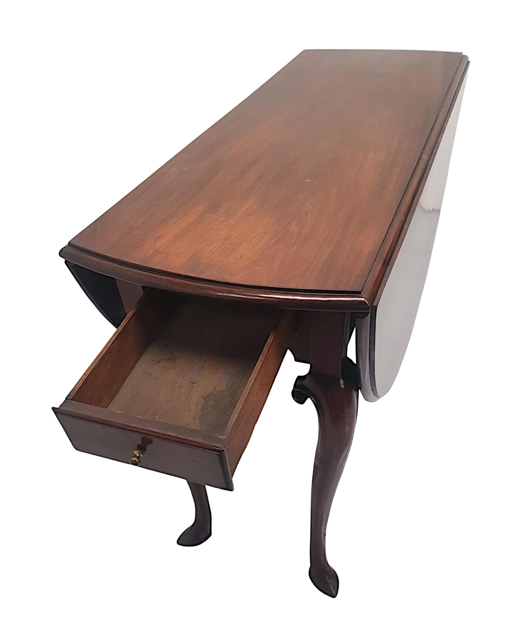 A very rare Irish Georgian solid mahogany drop leaf gate leg table of exceptional quality, finely hand carved with gorgeously rich patination and grain.  The well figured moulded and shaped top of rectangular form with curved ends, flanked with twin