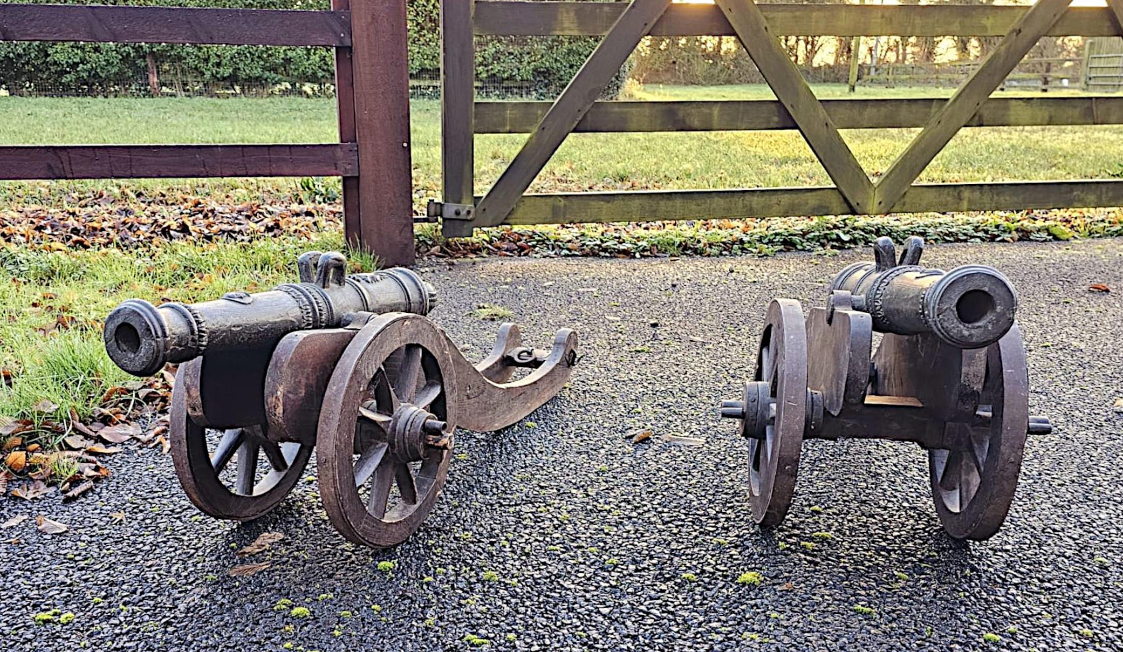 A very rare pair of 19th Century finely cast bronze barrelled signal cannons of exceptional quality with gorgeous detail and rich patination.  This fabulous pair of cannons have tapering barrels, flared muzzles with the top of each breech surmounted