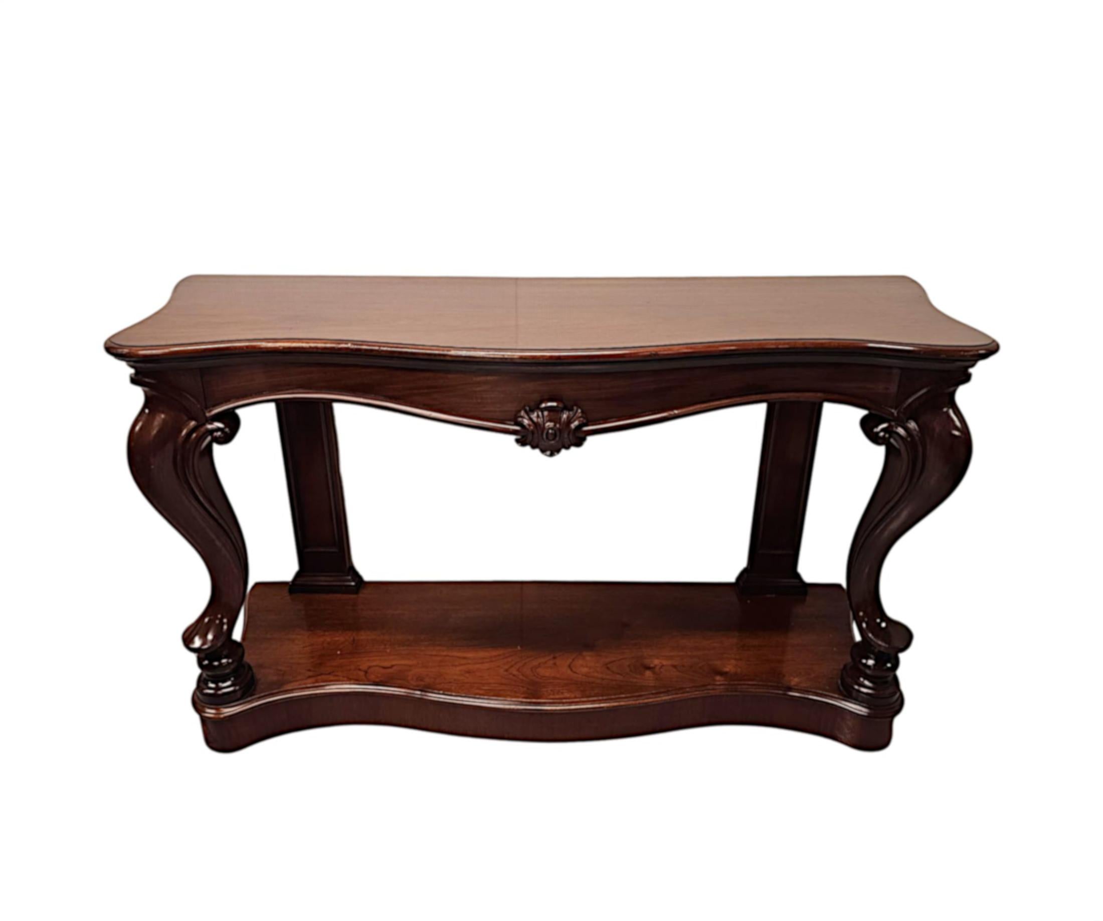 A very rare pair of 19th Century mahogany console tables.  This exceptional pair are stunningly hand carved with beautifully rich patination and fine grain.  The well figured moulded serpentine top of rectangular form is raised over an elegantly
