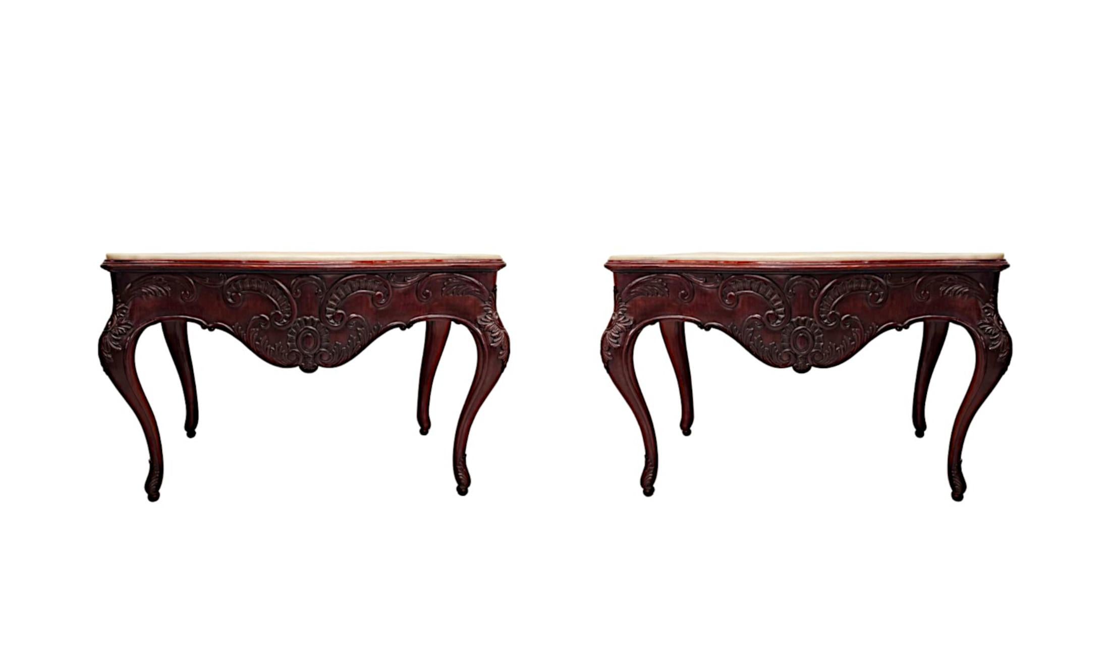A very rare pair of 19th Century well figured, mahogany marble top console tables, finely hand carved and of exceptional quality with gorgeously rich patination and fine grain. The stunning moulded, serpentine Carrara White marble top of rectangular