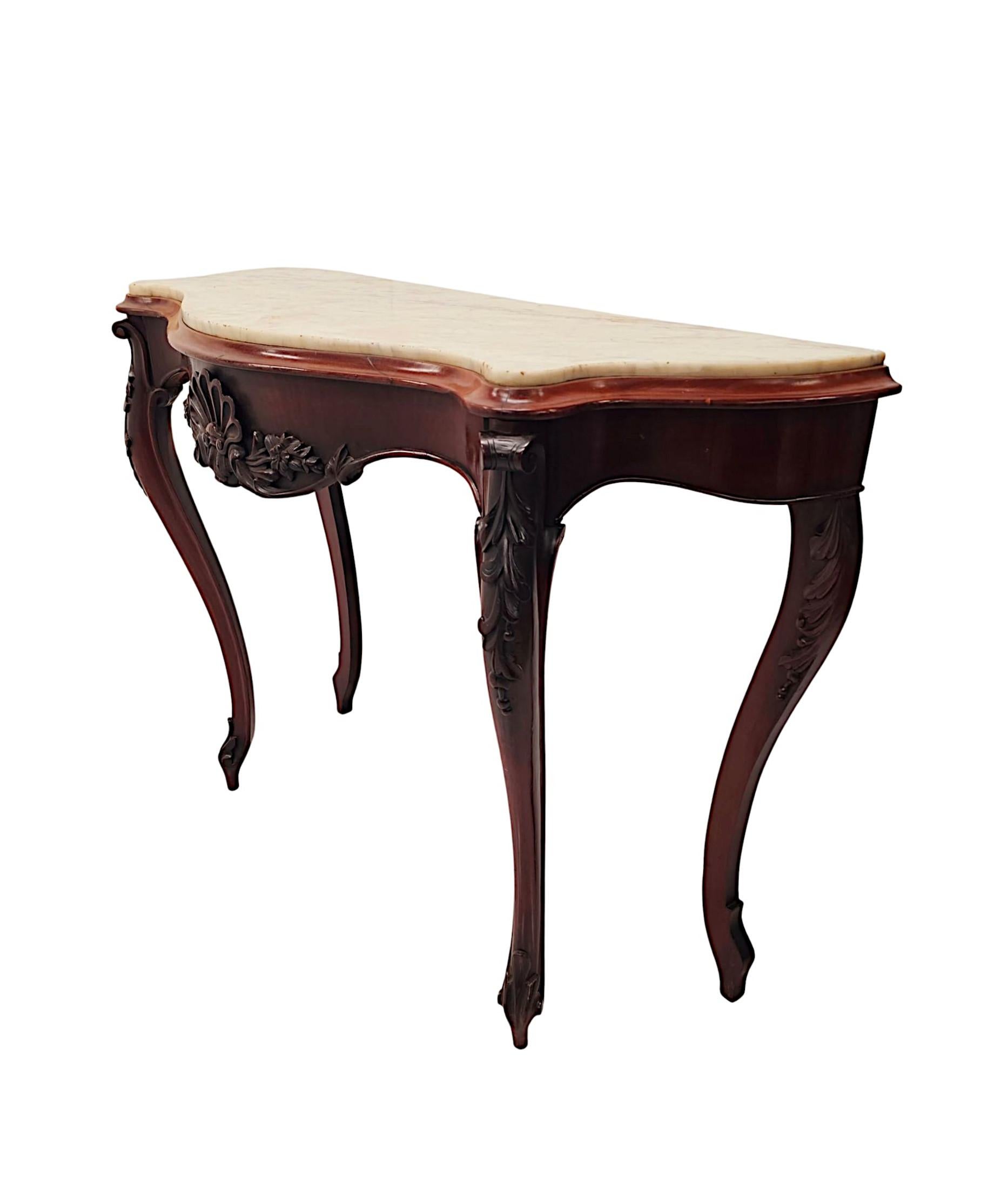 A very rare pair of 19th Century mahogany marble top console tables, of exceptional quality, superbly hand carved and richly patinated with fine grain.  The gorgeous, moulded white Carrara serpentine marble top of rectangular form is raised over a