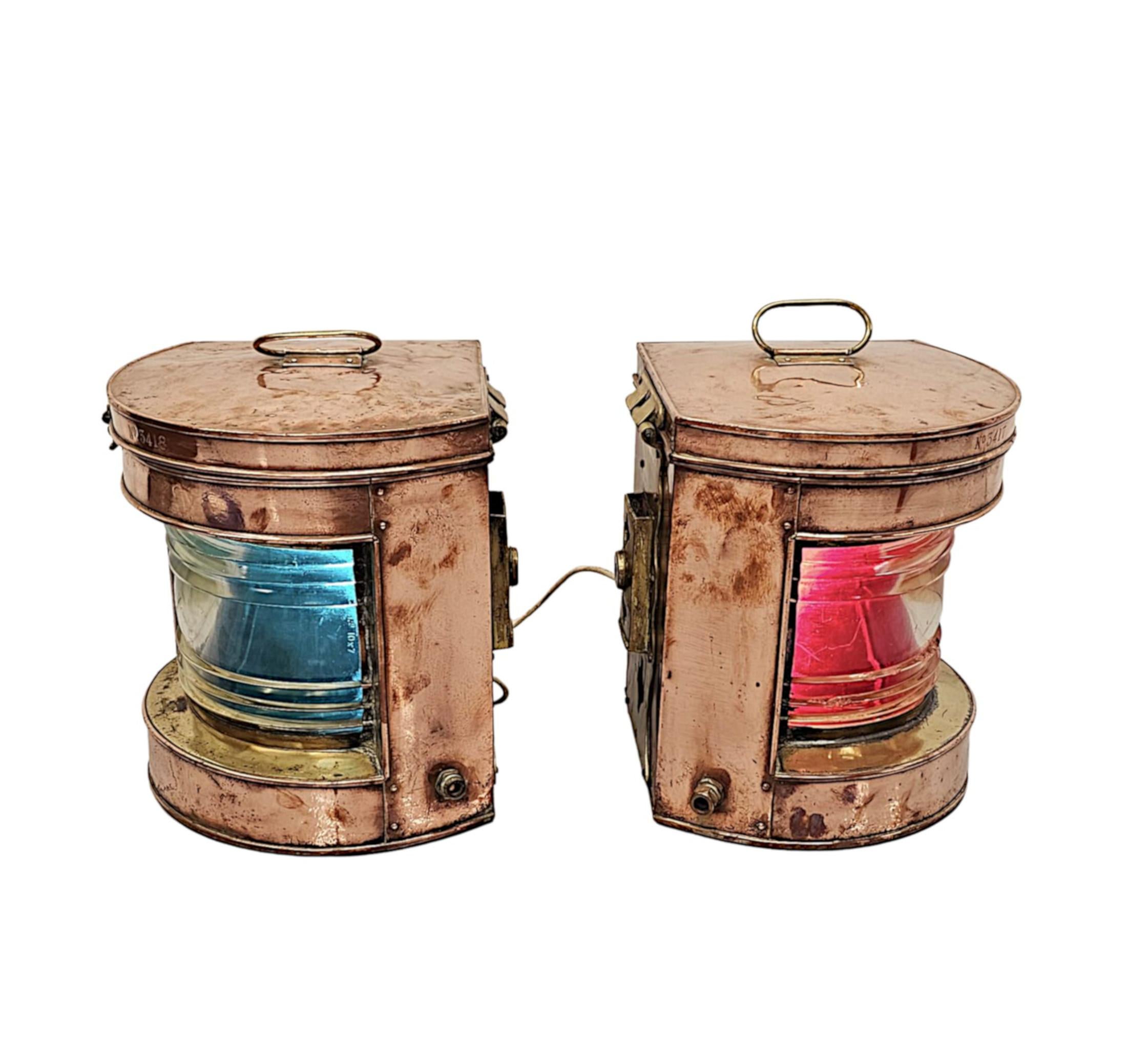 A very rare pair of early 20th Century copper and brass ships lanterns of fabulous quality and in full working order.  The beautifully patinated, moulded copper body of demilune form with brass fittings throughout, features red and blue fresnel