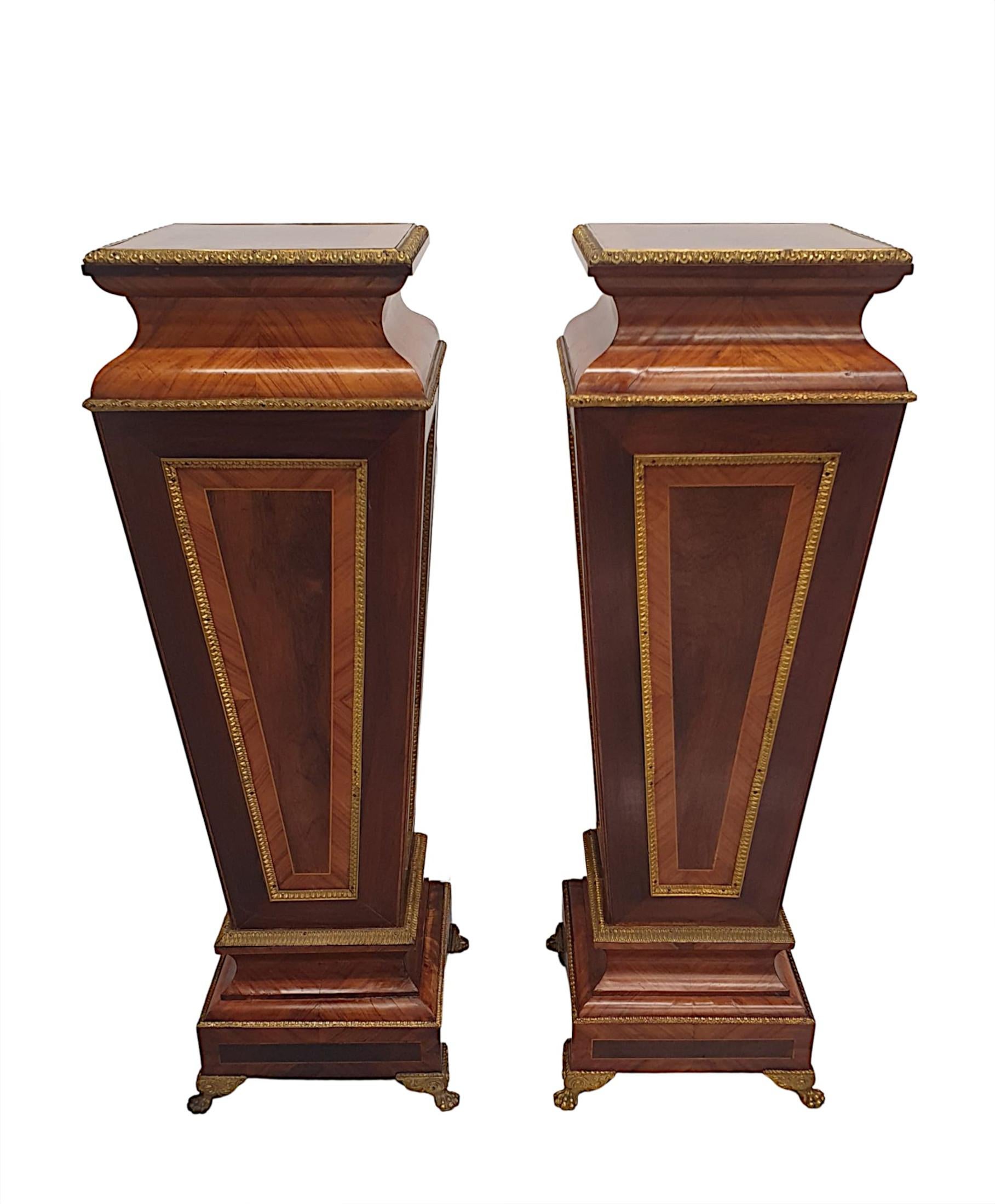 A very rare pair of 19th Century kingwood and fruitwood tables / plant or bust stands with beautifully rich patination and fine grain. This exceptional pair are fabulously hand carved, crossbanded and line inlaid with finely cast ormolu mounts