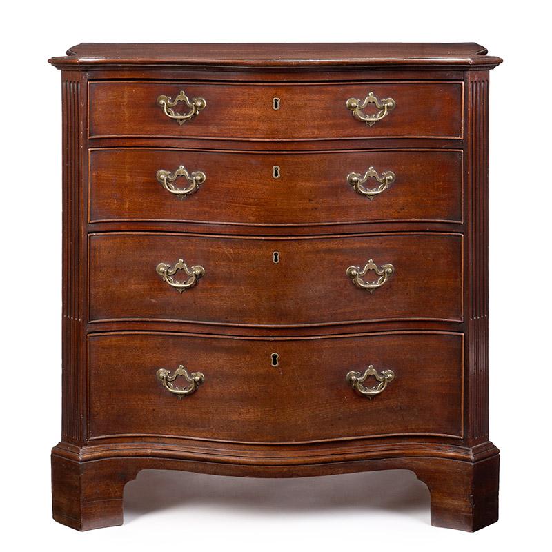 A fine and Very Rare Mid-18th Century mahogany Serpentine four- drawer chest of uniquely small proportions. The figured veneered top with four graduated drawers below and flanked by bold stop-fluted canted columns . The generously shaped sides also
