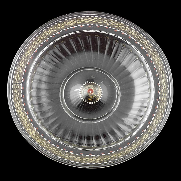 A very rare Venetian low footed glass bowl, circa 1500–1525; The shallow tray of the bowl moulded with a series of ribs radiating from the raised centre; the broad rim decorated with an intricate pattern of gilded scales embellished with white, red