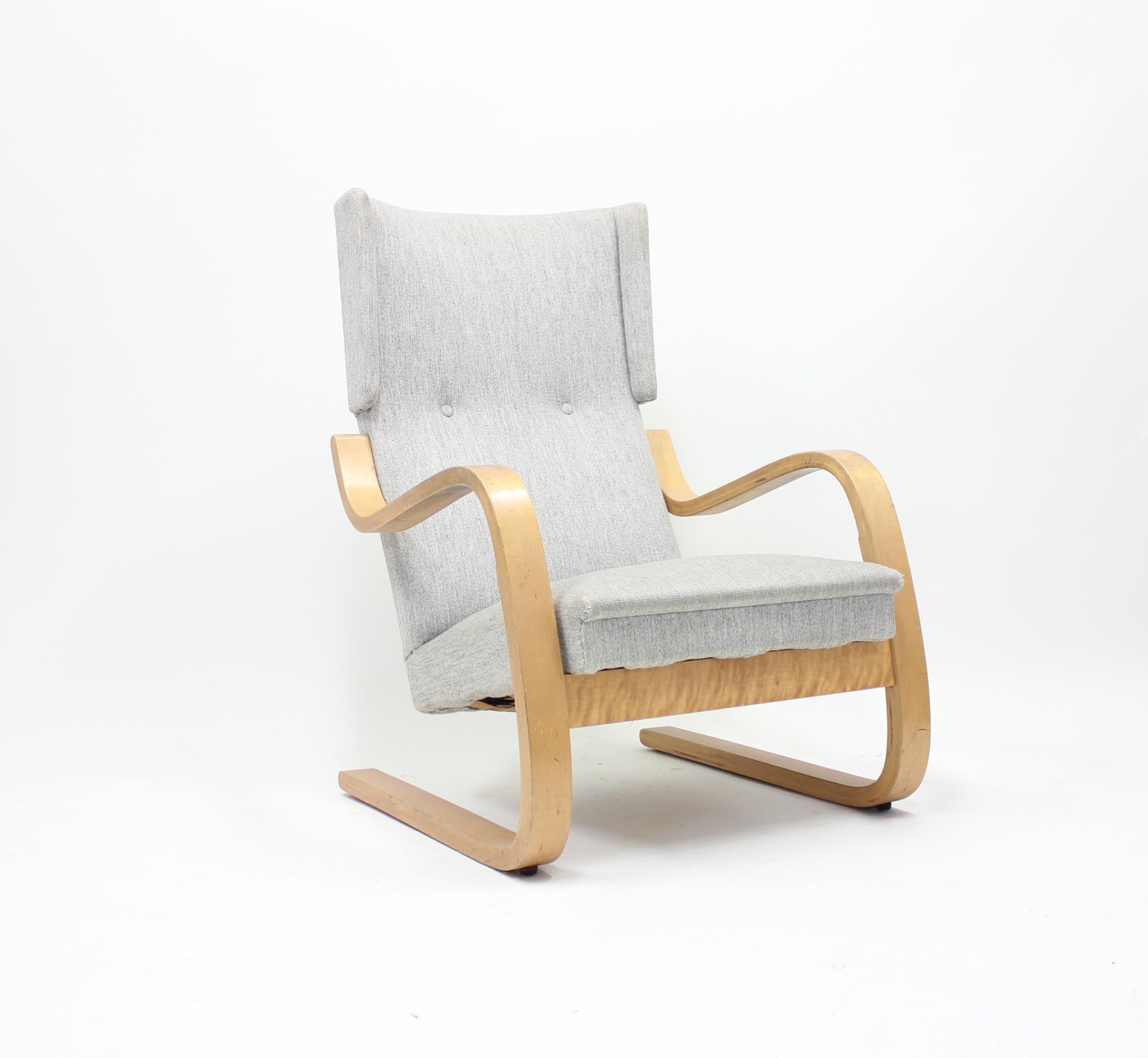 Early production, model 36/401 easy chair, by Alvar Aalto for Artek, Hedemora, circa 1950. Frame of steam bent birch and later upholstery in a grey wool fabric commissioned by the original owner. It has a very special provenance. This single owner