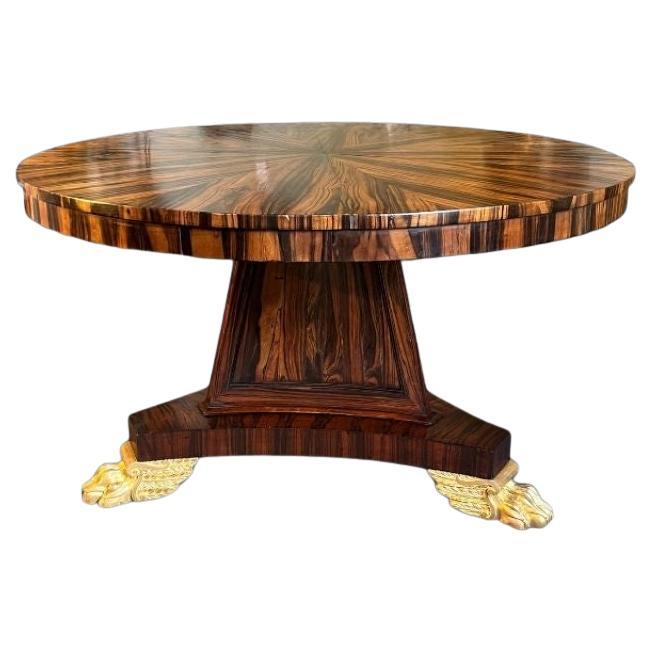 A very striking Regency Coromandel Centre Table with gilt paw feet. For Sale