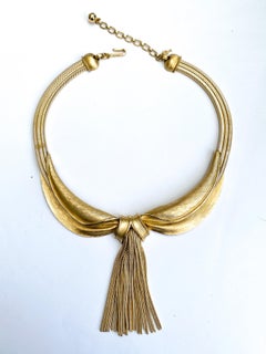 A very stylish gilt metal 'collar' necklace, with tassel, Trifari, 1960s, USA.