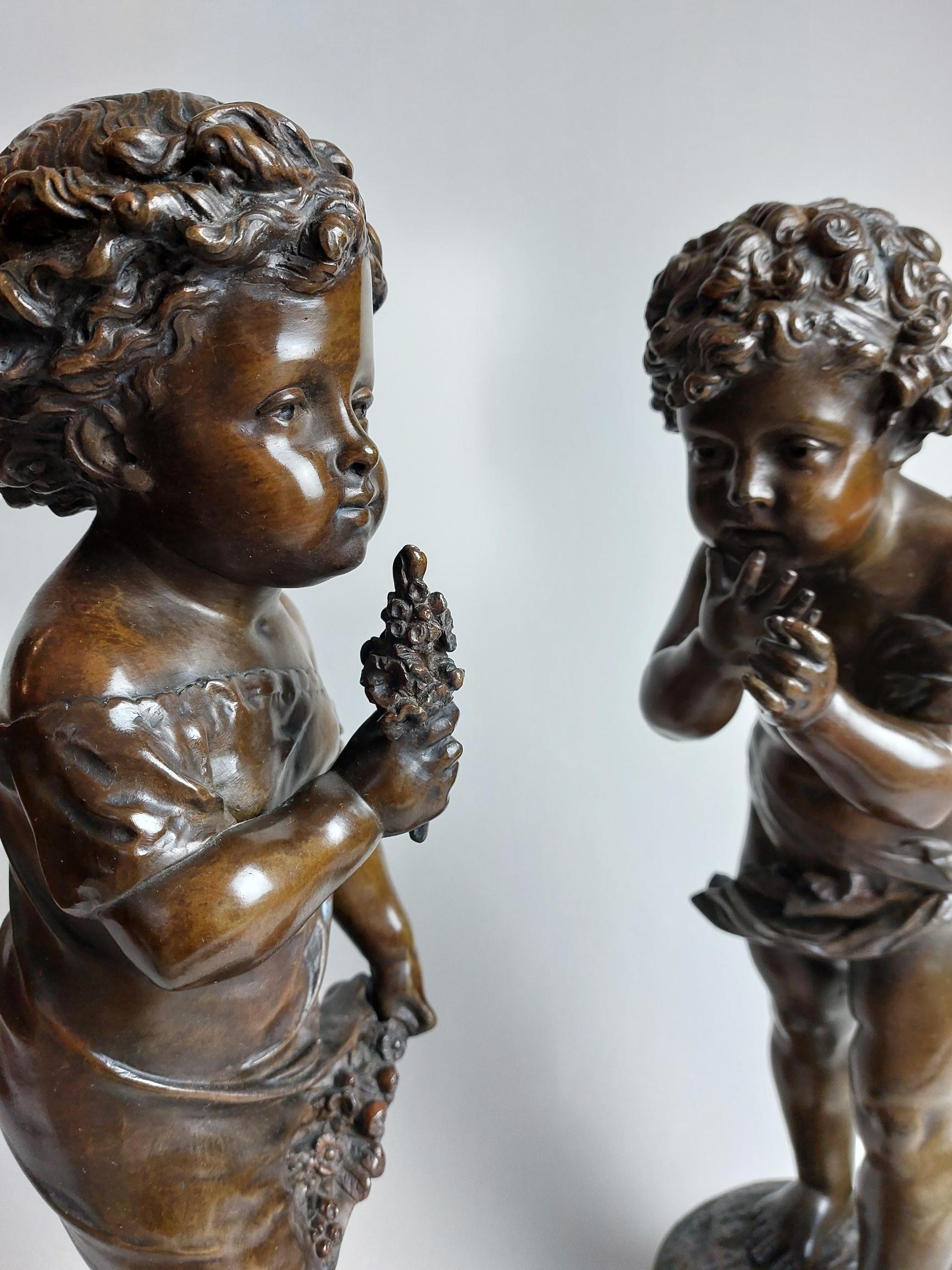 A very sweet pair of 19th century French bronzes depicting a cherub and a young girl. Signed Bulio.

The toddler girl holds a small posy of flowers, the winged Cherub, perhaps cupid? Also resembles a toddler, he leans forward curiously smelling