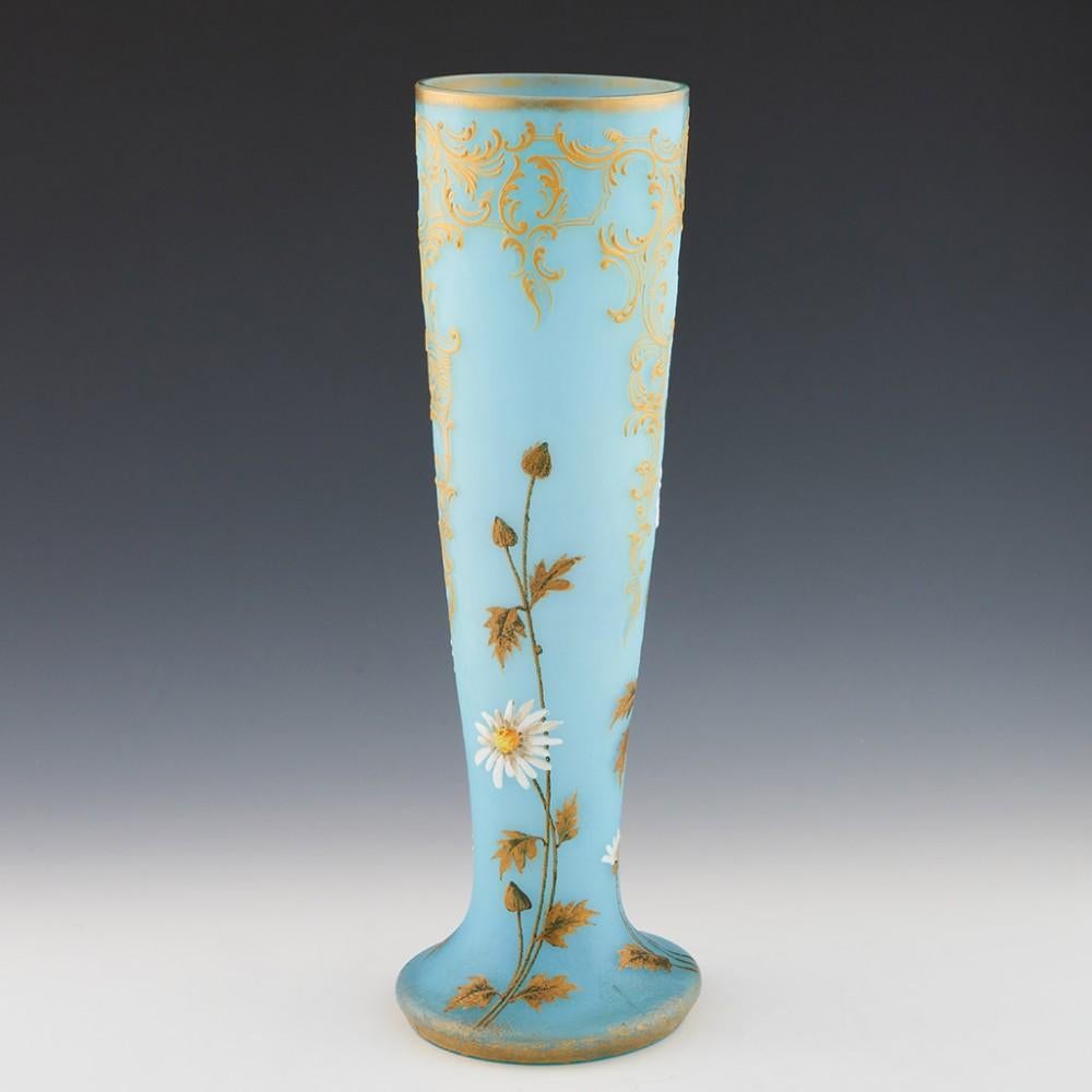Heading : A very tall Legras enamelled cameo vase from c1900 made at the Verreries de Saint-Denis, Paris, France. The bowl features high relief enamelled Ox-eye daisies and gilded leaves. High relief yellow c-scoll gold pendants with clear sections