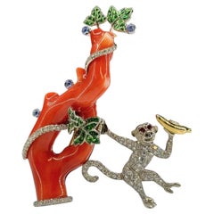 A very unique 18K gold brooch, a diamonds set monkey on a coral tree branch