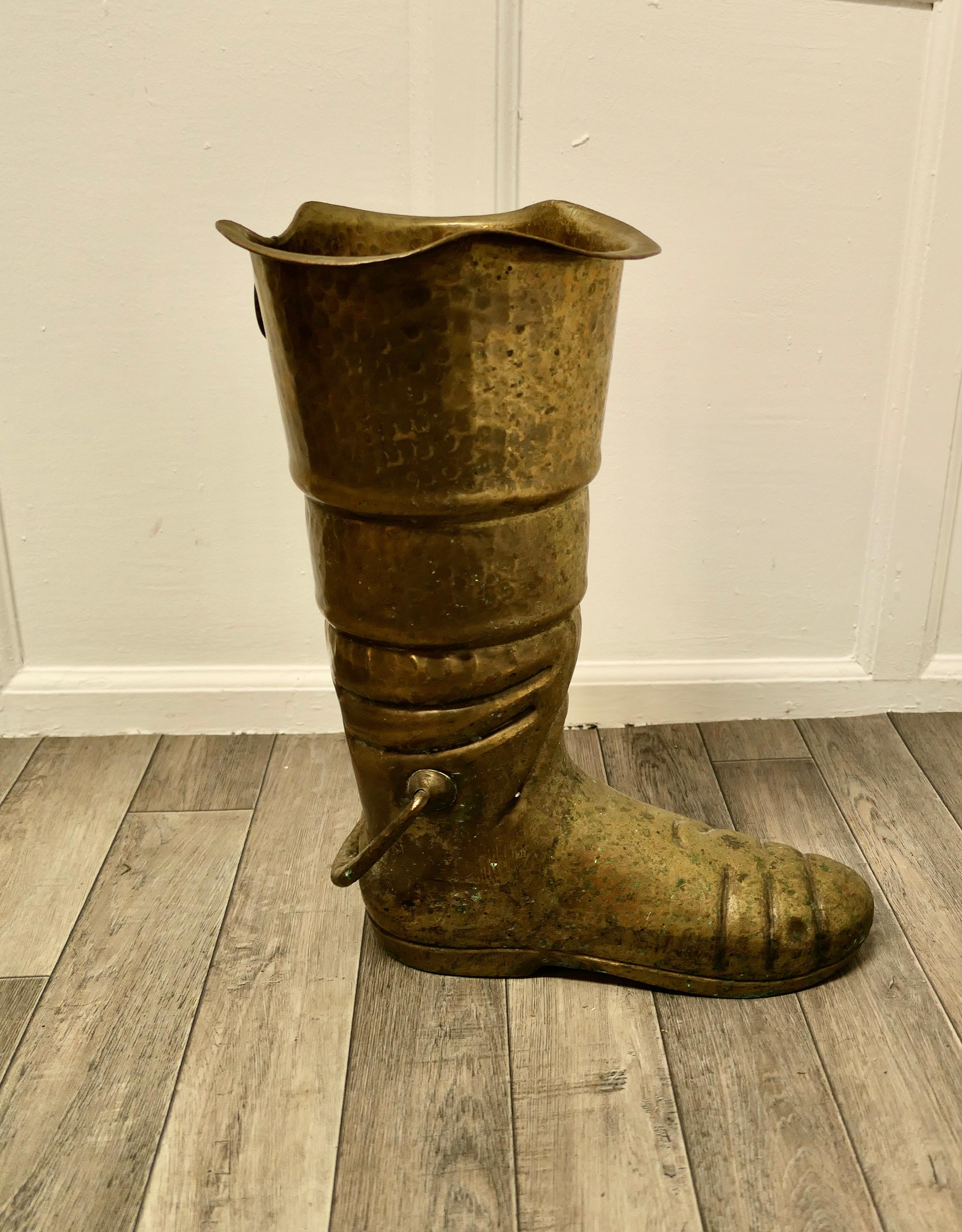 A very unusual stick stand a brass deep sea diver’s boot.

This is a very unusual slightly quirky stick stand, the boot is made in hand beaten brass and will hold many sticks or umbrellas. 
The stand is in good used condition, it is 24” high and