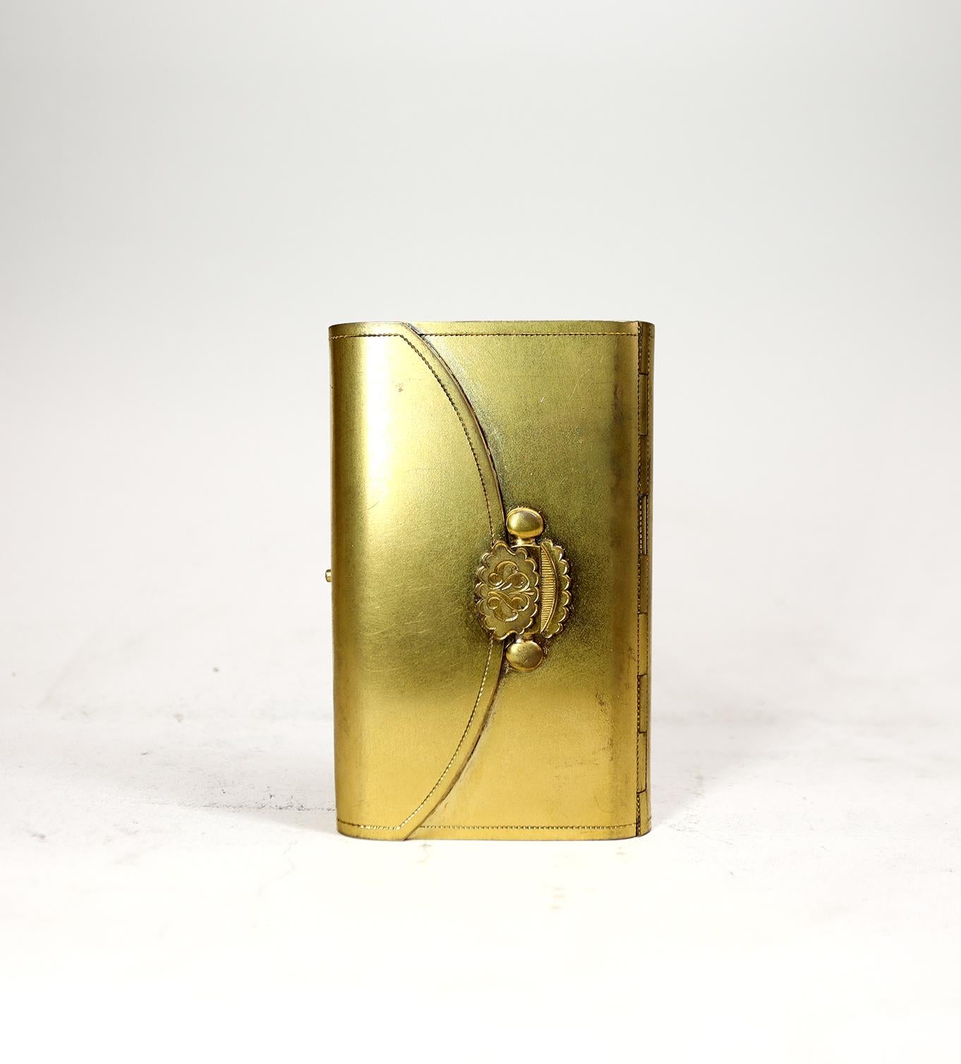 A Very Unusual travel clock in the shape of a prayer book
£1,750.00
Possible one of a kind travel clock in the shape of a purse or prayer book, with a false clasp and snap closure. This beautifully gilded object fits in the palm of your hand and is
