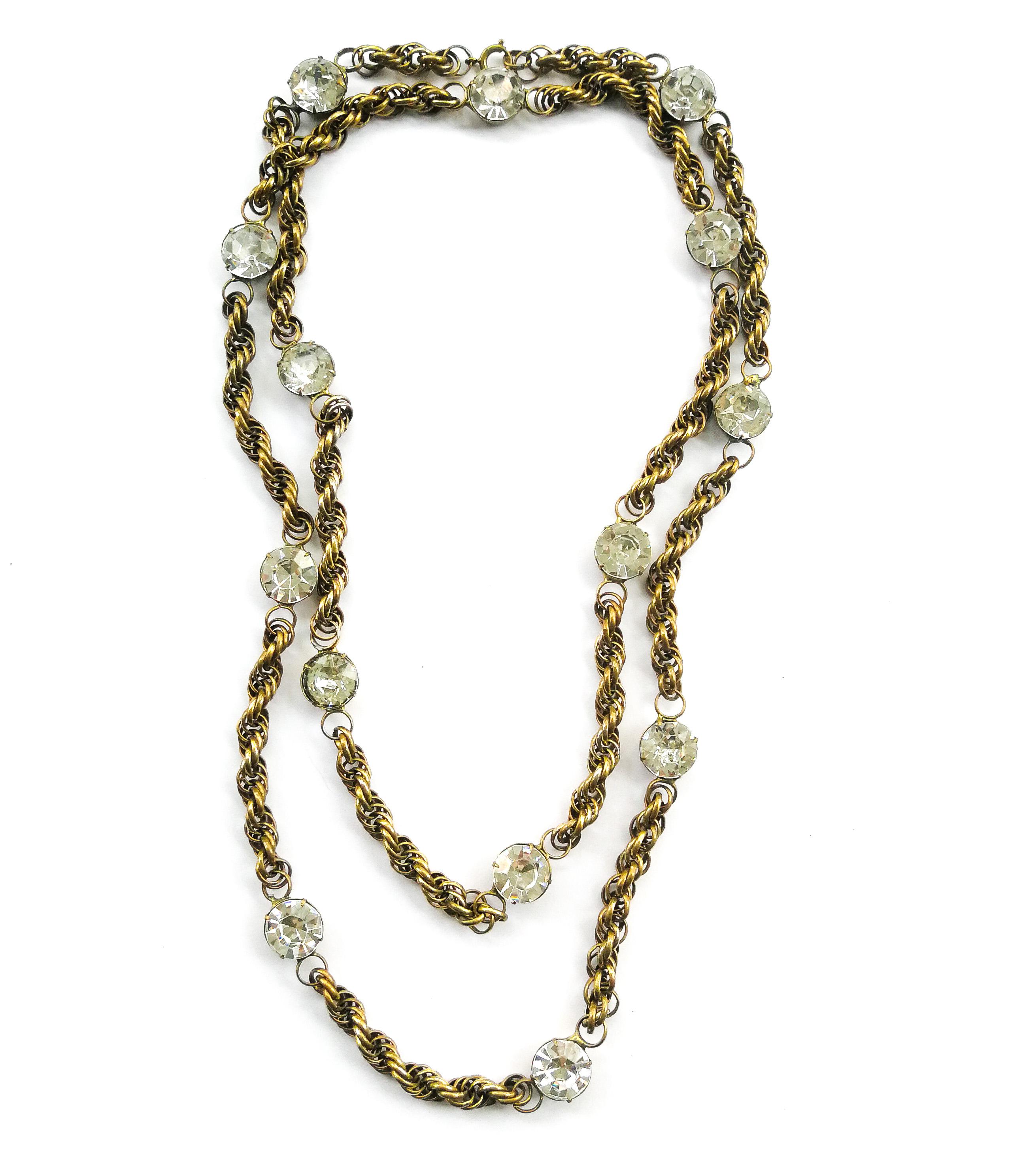 A very wearable and very long chain necklace that can be doubled up or even tripled to make a shorter multi row look. Made from brass, and of very high quality, large individual clear paste stones in settings  are intermittently but regularly