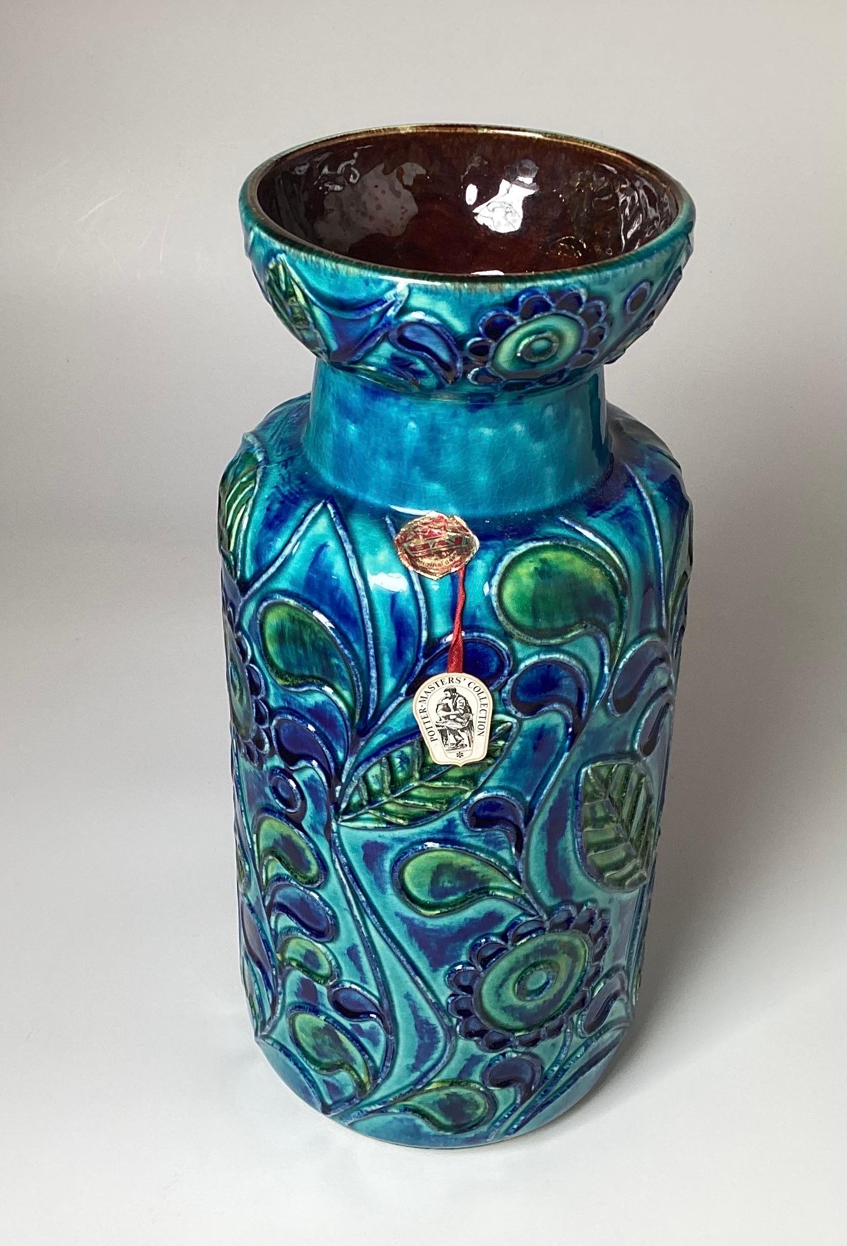 Vibrant blue hand painted ceramic vase by Bay Keramik, Germany.  Bold blue gradient with heavy design with embossed floral and leaf decoration. With ordinal tag. 16.5 inches tall 