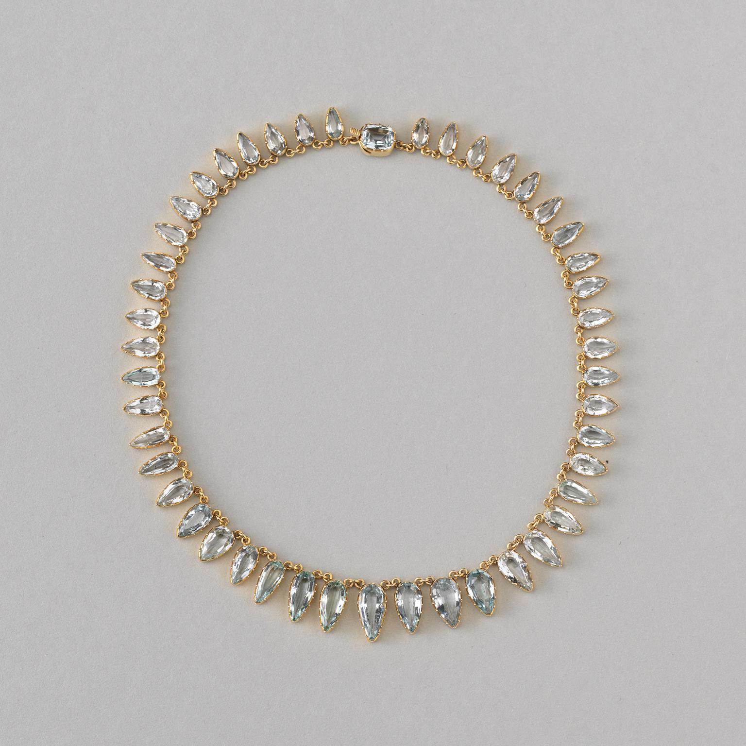 A stunning 15-carat yellow gold necklace with 46 drop-shaped aquamarines diminishing in size, with the largest stone in the middle. Beautiful open setting, in the clasp a cushion cut aquamarine. England, circa 1890-1900.

Weight: 30.26 grams
Length: