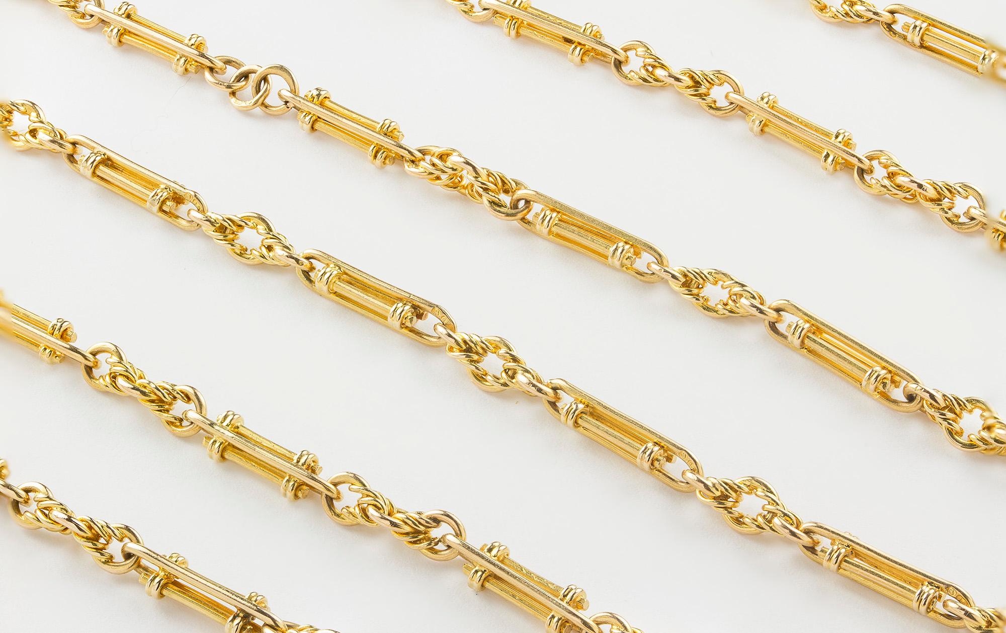 A Victorian 18ct long fancy link guard chain, each openwork bar design link alternating with a decorative knot link, no clasp, circa 1860, measuring approximately 142cm, gross weight 61.6 grams,

Should you choose to make this purchase we will