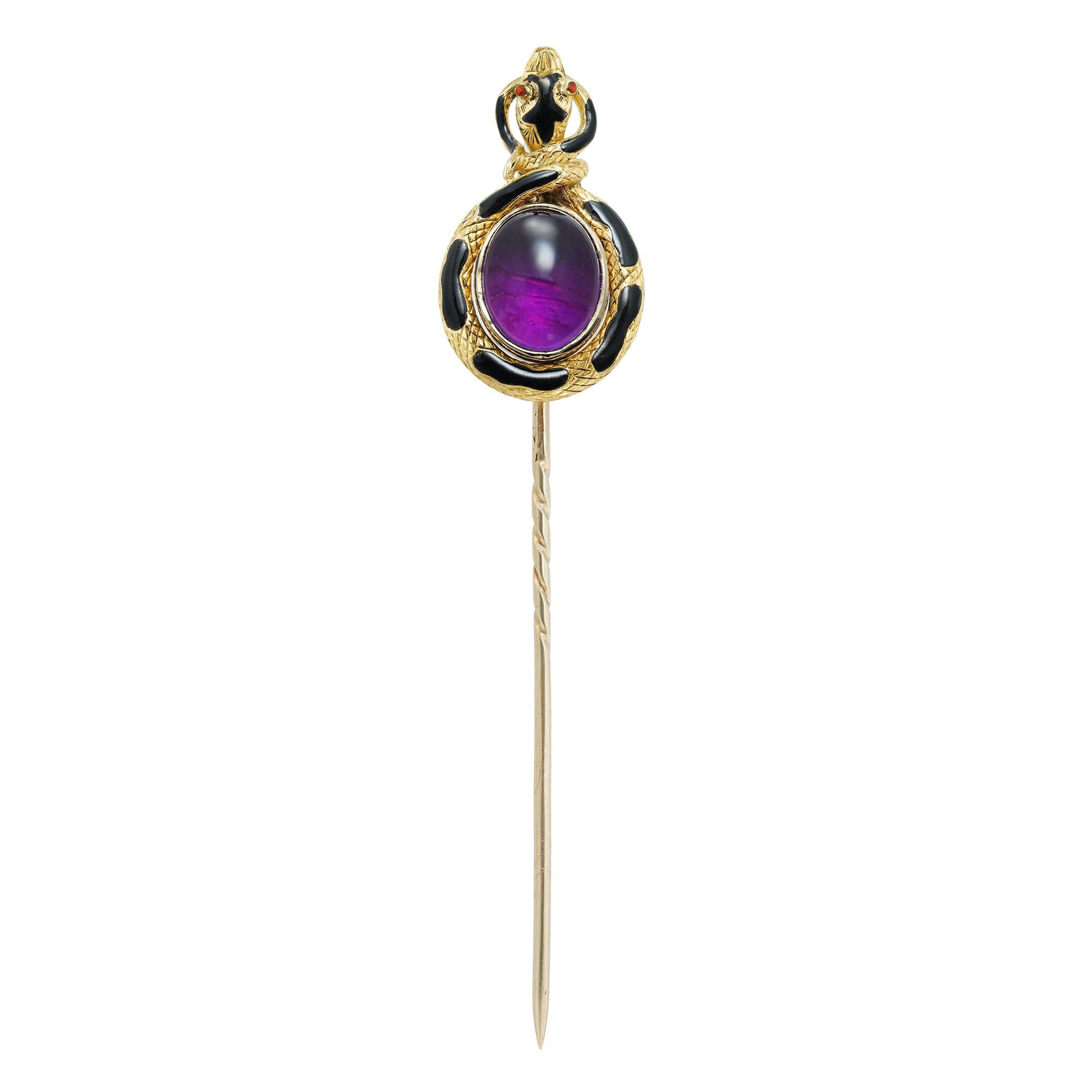 A Victorian amethyst and black enamel snake stick pin, the cabochon-cut amethyst measuring 9.6 x 8mm, rubover-set in yellow gold surrounded by a yellow gold snake, the body with black enamel decorations and the head with red enamel eyes, all mounted