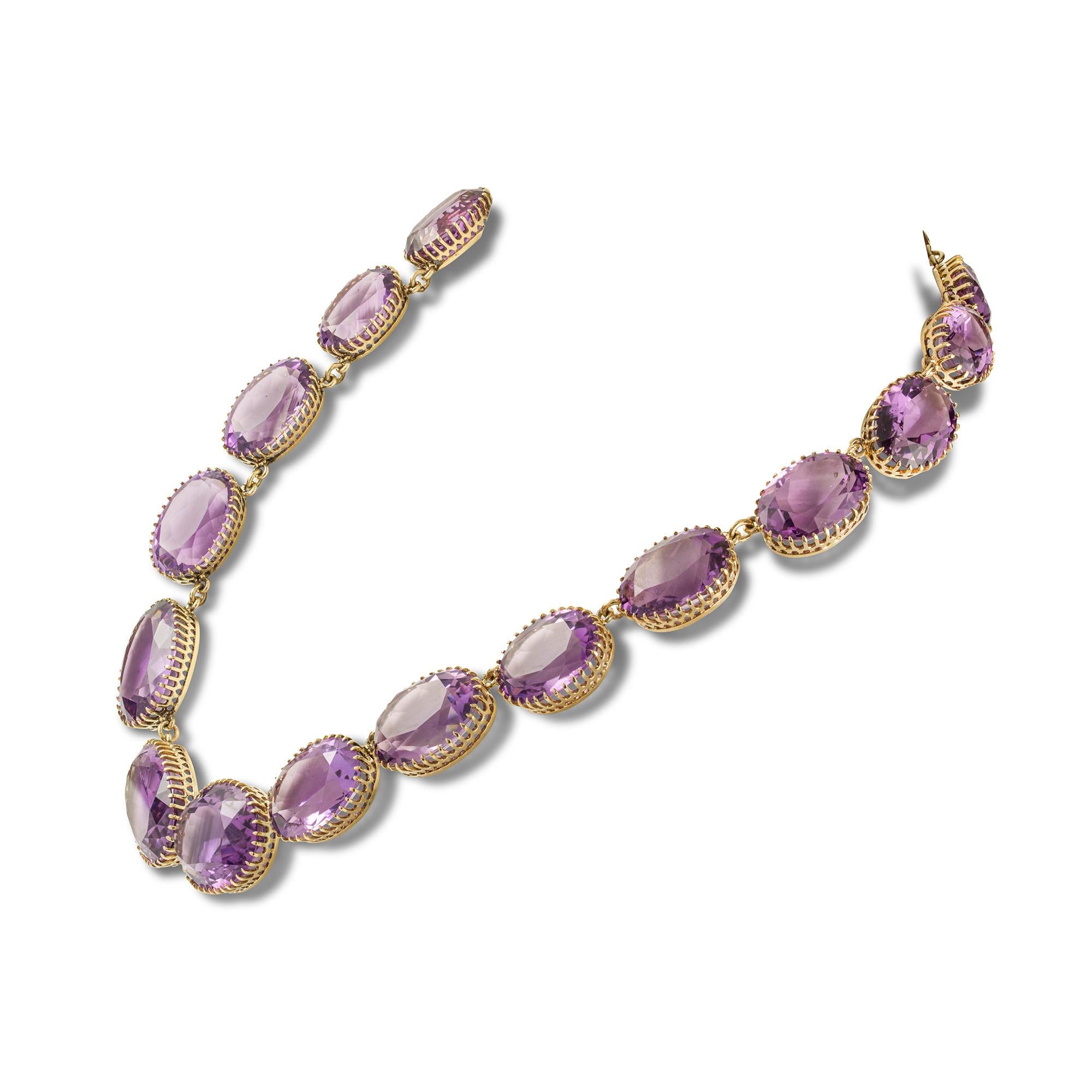 A Victorian amethyst riviere necklace, the nineteen graduated oval mixed-cut amethysts, measuring from 15x10mm to 22.2 x16.2mm, each cut down collet set to yellow gold mounts, set with gold snap clasp,  circa 1870, measuring approximately 37cm long,