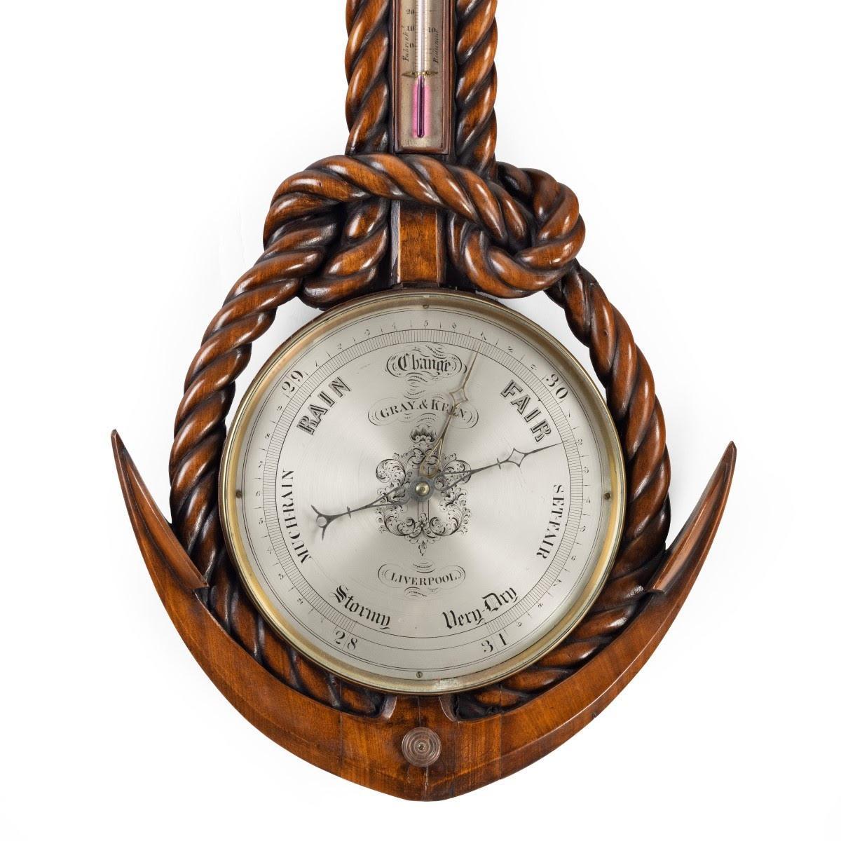 The 10 1/2-inch silvered dial of this walnut barometer is set within the arms of an anchor and coil of knotted rope which passes through a ring handle, the trunk inset with a thermometer, signed ‘Gray & Keen, Liverpool’. English, circa 1860.