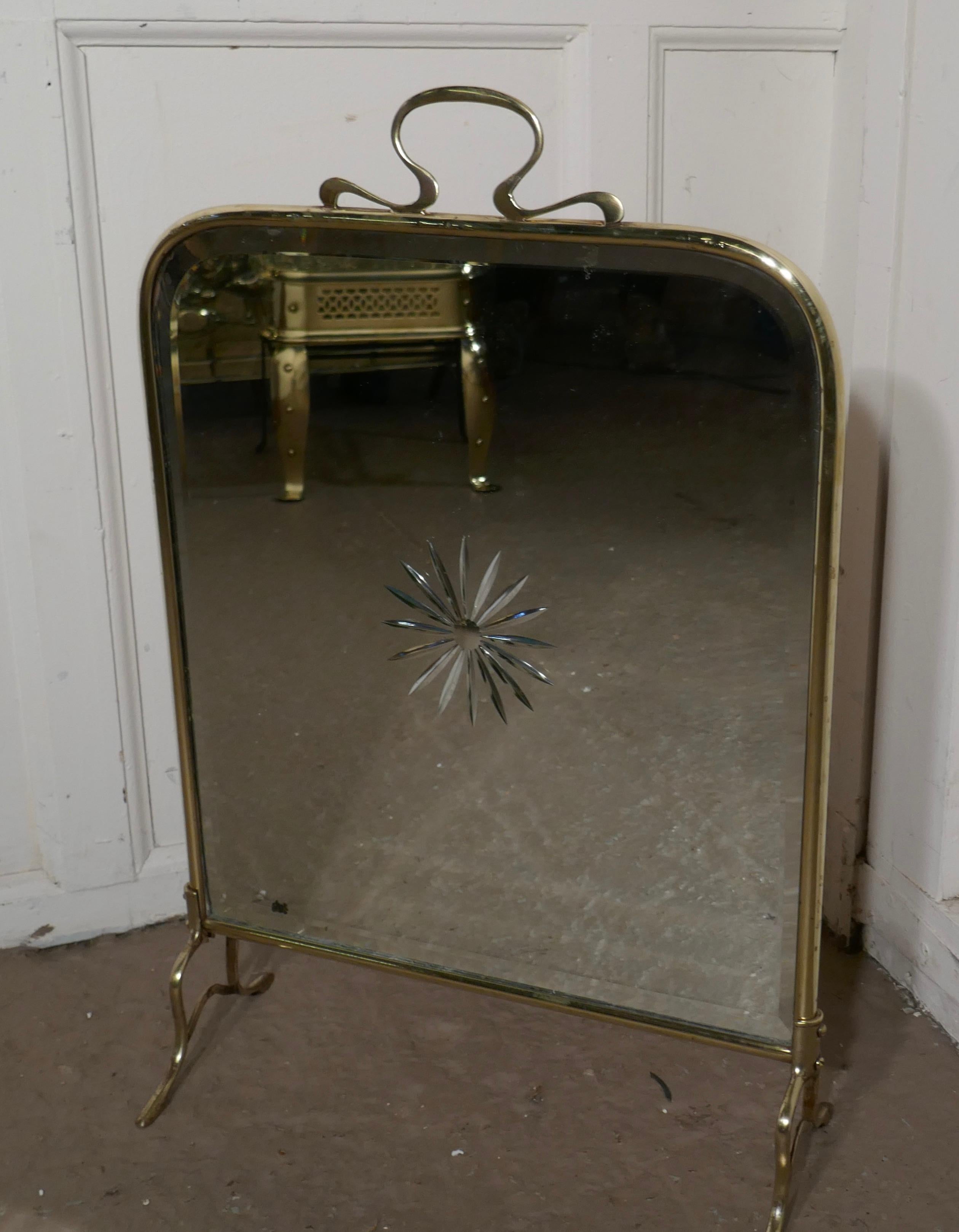 A Victorian Art Nouveau brass and sunburst mirror fire screen

This is a most decorative fire screen it has a brass frame and stand, the mirror has an etched Starburst in the centre
The screen is in good sound condition, there is very minor