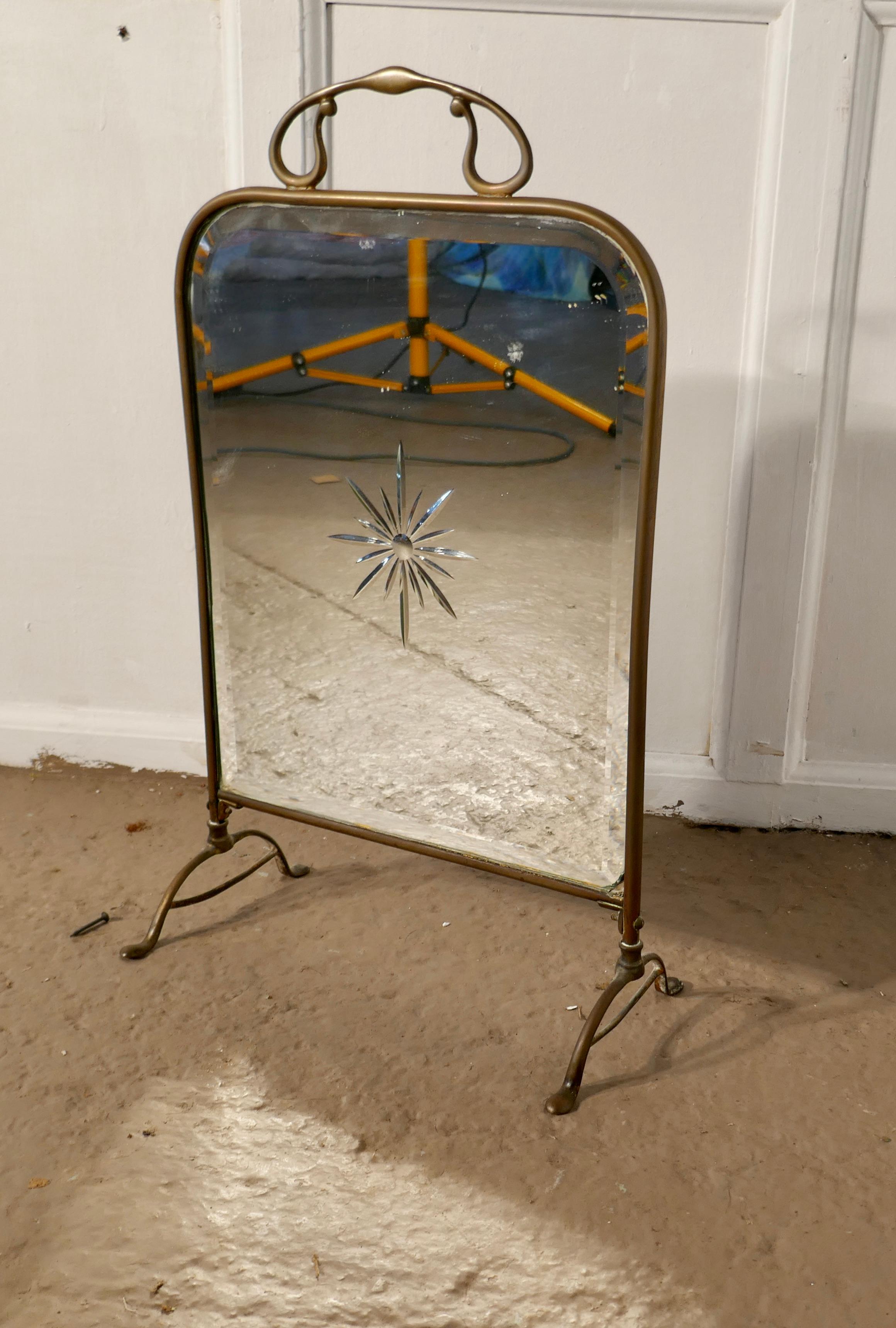A Victorian Art Nouveau brass and sunburst mirror fire screen

This is a most decorative fire screen it has a brass frame and stand, the bevelled mirror has an etched starburst in the centre, and a typical Art Nouveau style handle on top
The